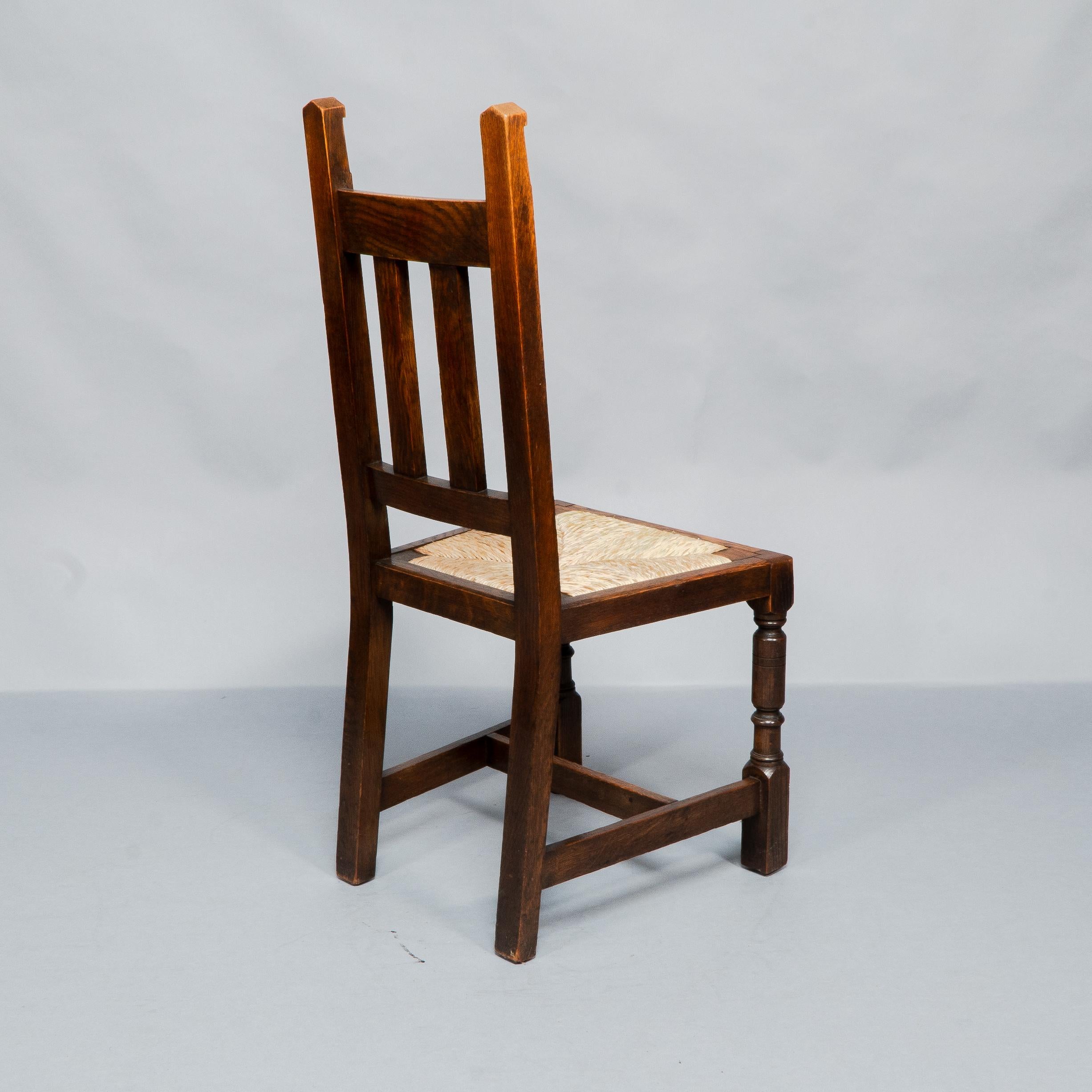 Liberty & Co. A Set of Six Arts & Crafts Oak Arrowhead Rush Seat Dining Chairs. For Sale 3