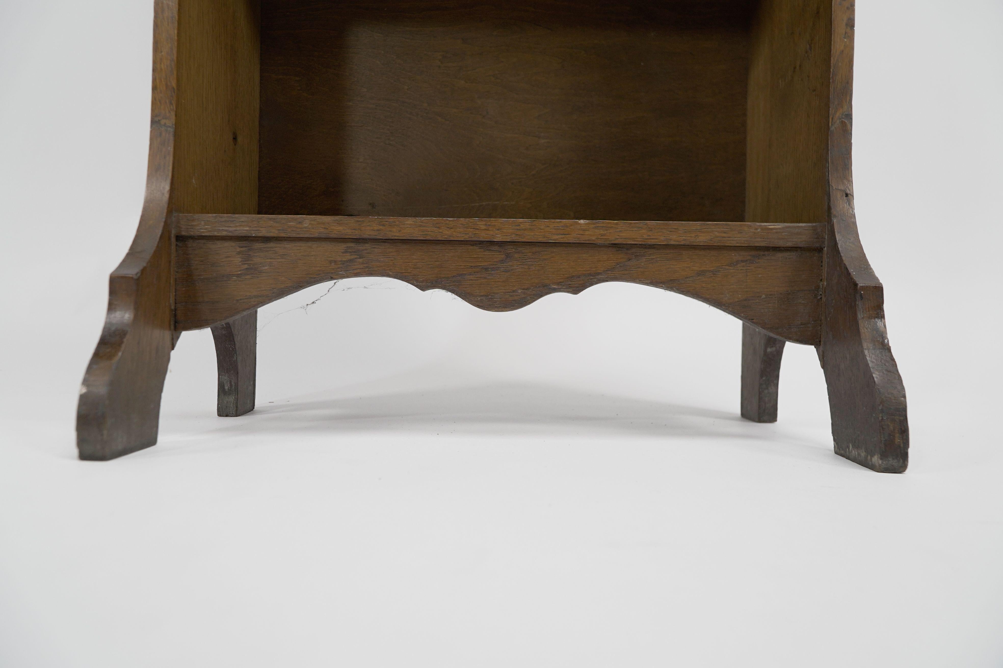 Liberty & Co. A slim Arts and Crafts oak bookcase with stylized floral cut-outs For Sale 1