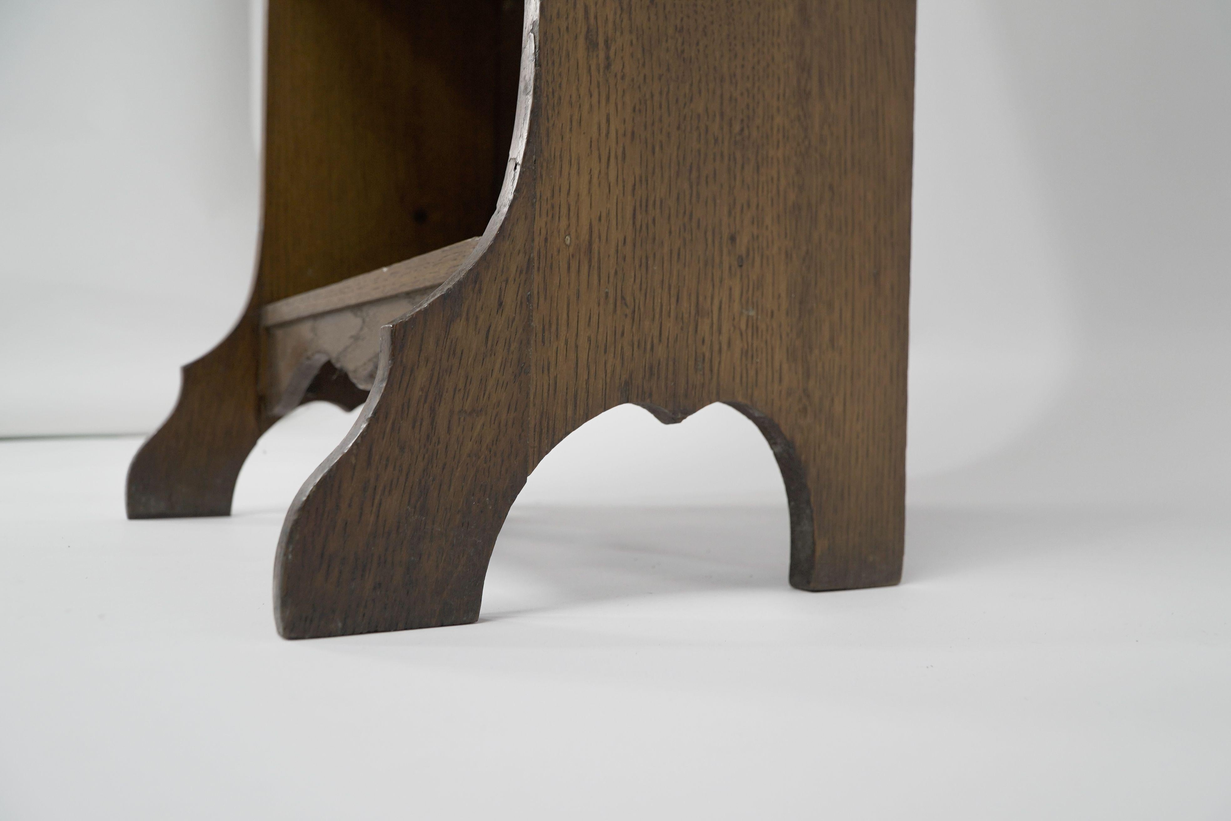 Liberty & Co. A slim Arts and Crafts oak bookcase with stylized floral cut-outs For Sale 2