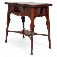 Liberty & Co. an Anglo-Moorish Arts & Crafts Walnut Fold over Card & Games Table