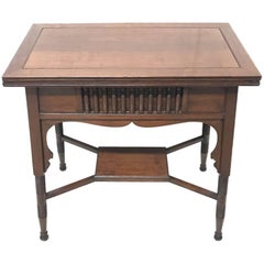 Liberty & Co. an Anglo-Moorish Arts & Crafts Walnut Fold over Card & Games Table