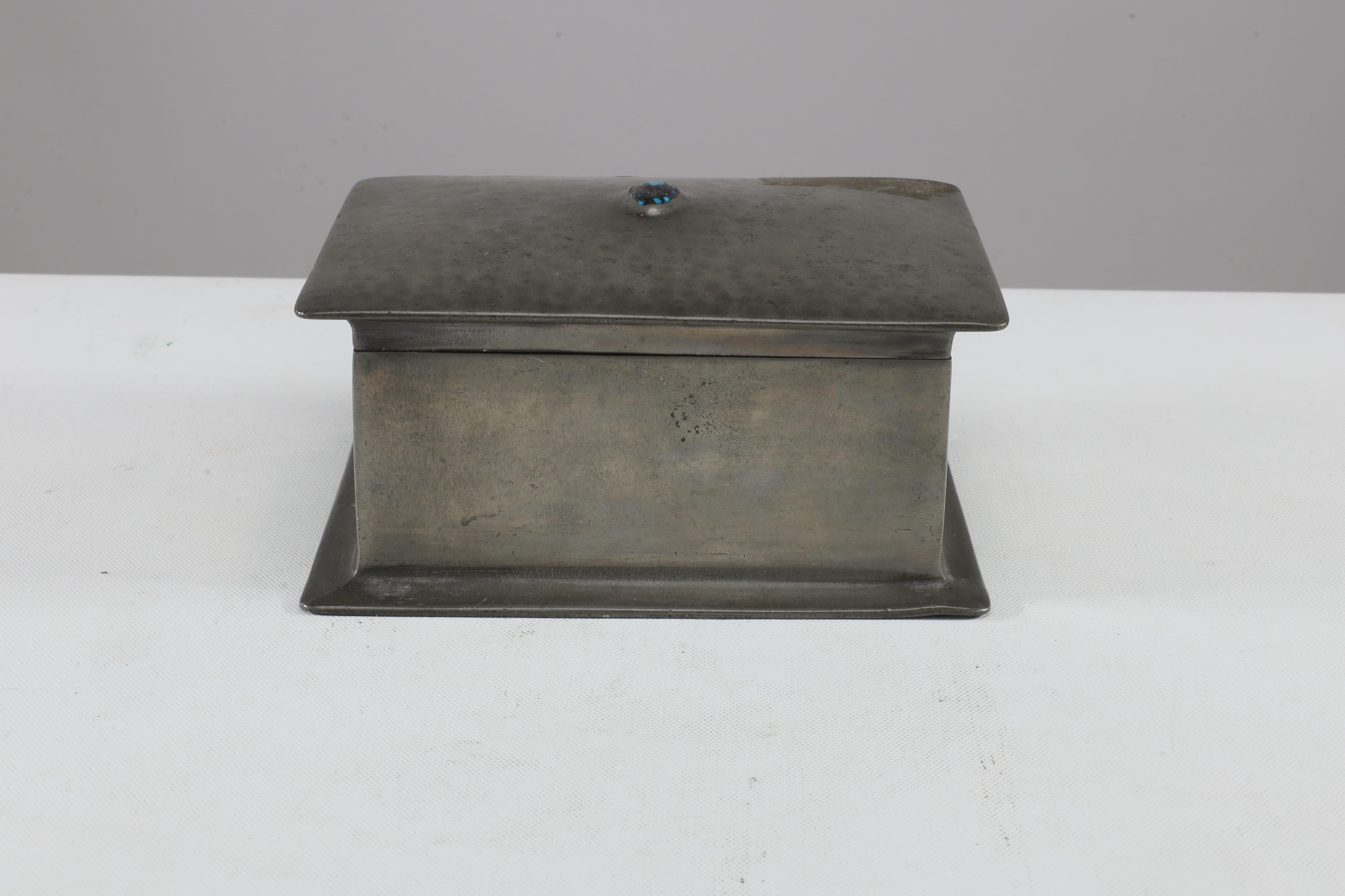 Liberty & Co. An Arts & Crafts ceder lined pewter jewelry box with an Abalone blue semi-precious stone to the lid. Tudric 082 stamped to base. Liberty launched its Tudric pewter range in 1902.Initially, Liberty imported as well as commissioned items