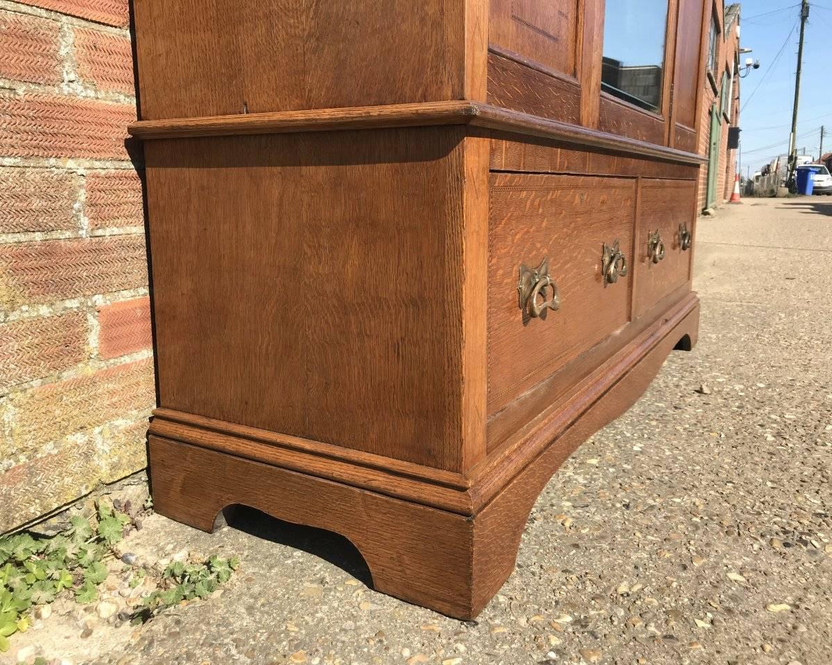 Hand-Crafted Liberty & Co, an Arts & Crafts Oak Double Wardrobe with Stylised Floral Inlays