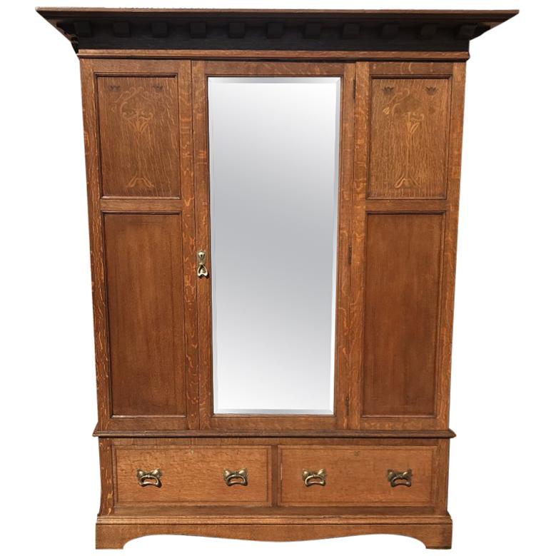 Liberty & Co, an Arts & Crafts Oak Double Wardrobe with Stylised Floral Inlays