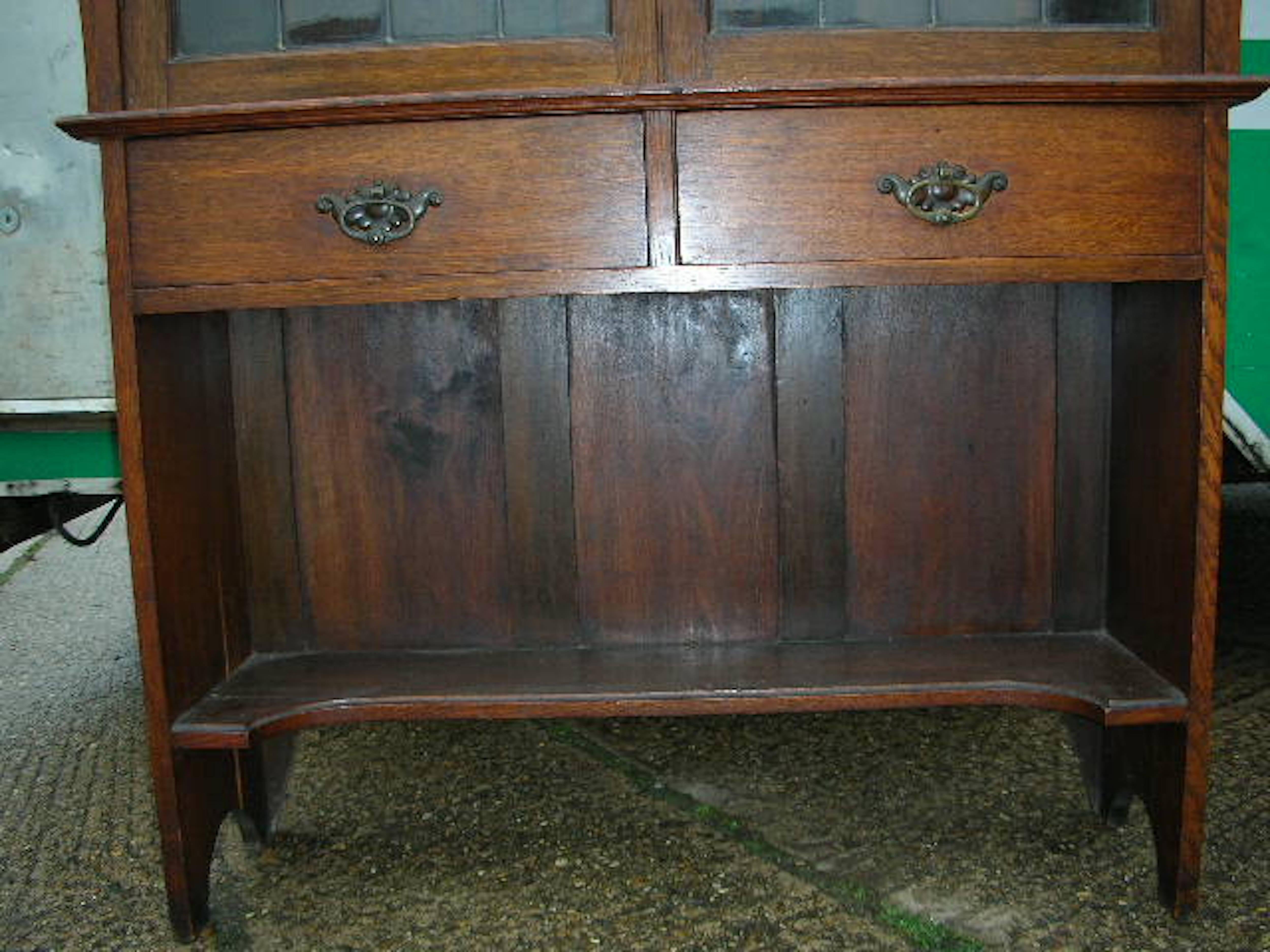 Hand-Crafted Liberty & Co. an Arts & Crafts Oak Glazed Bookcase with Stylized Heart Details For Sale