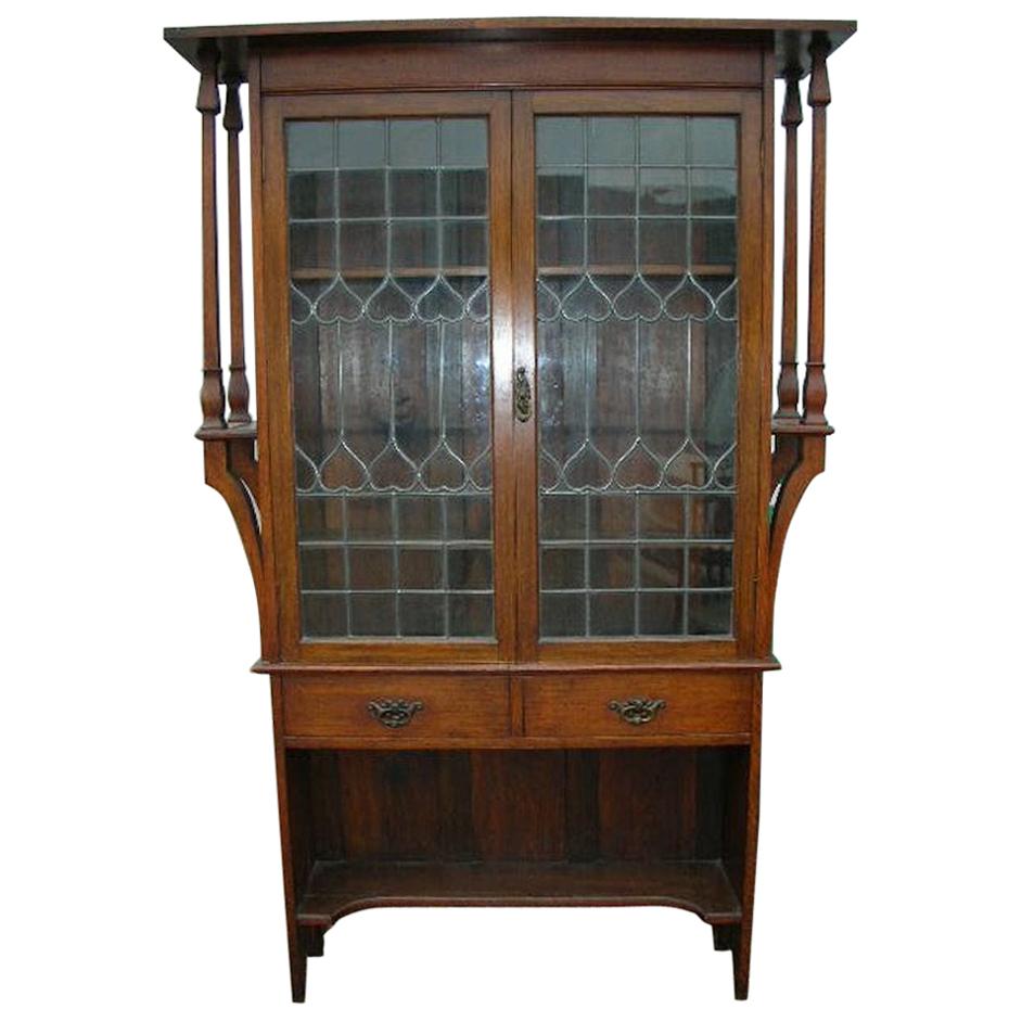 Liberty & Co. an Arts & Crafts Oak Glazed Bookcase with Stylized Heart Details For Sale