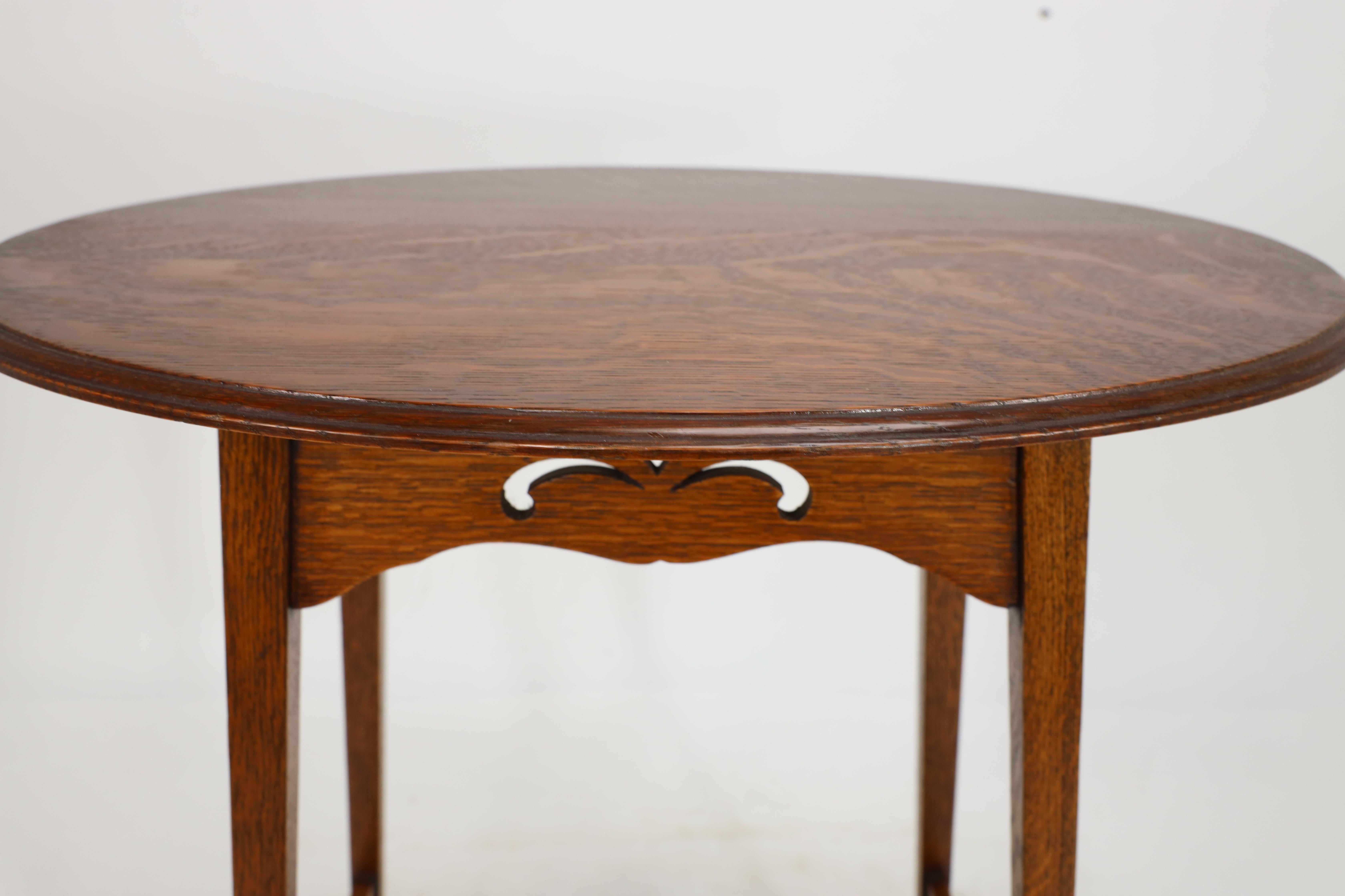Liberty & Co. An Arts & Crafts oak oval top side table with heart cut-outs 6