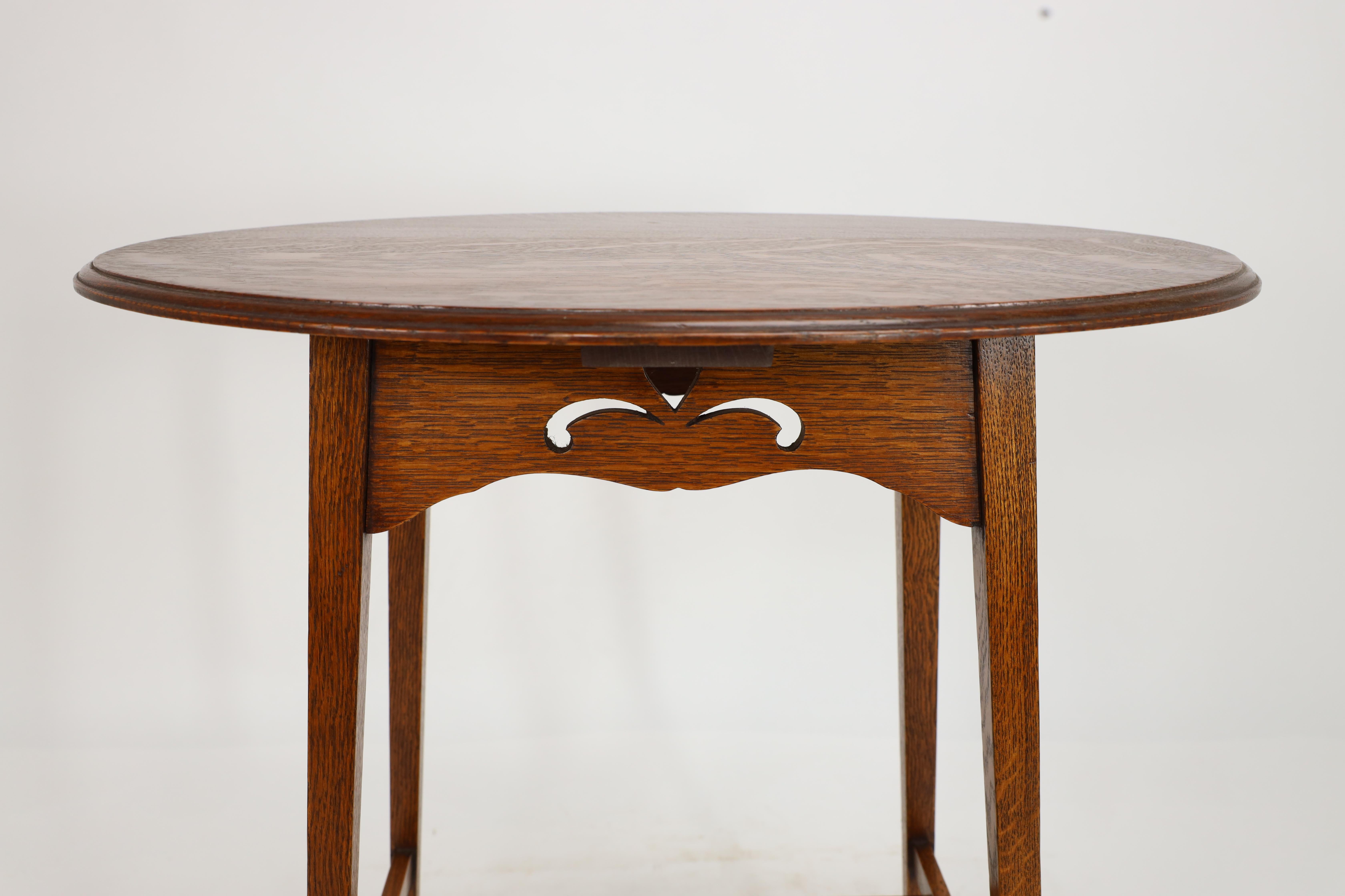 Liberty & Co. An Arts & Crafts oak oval top side table with heart cut-outs 7