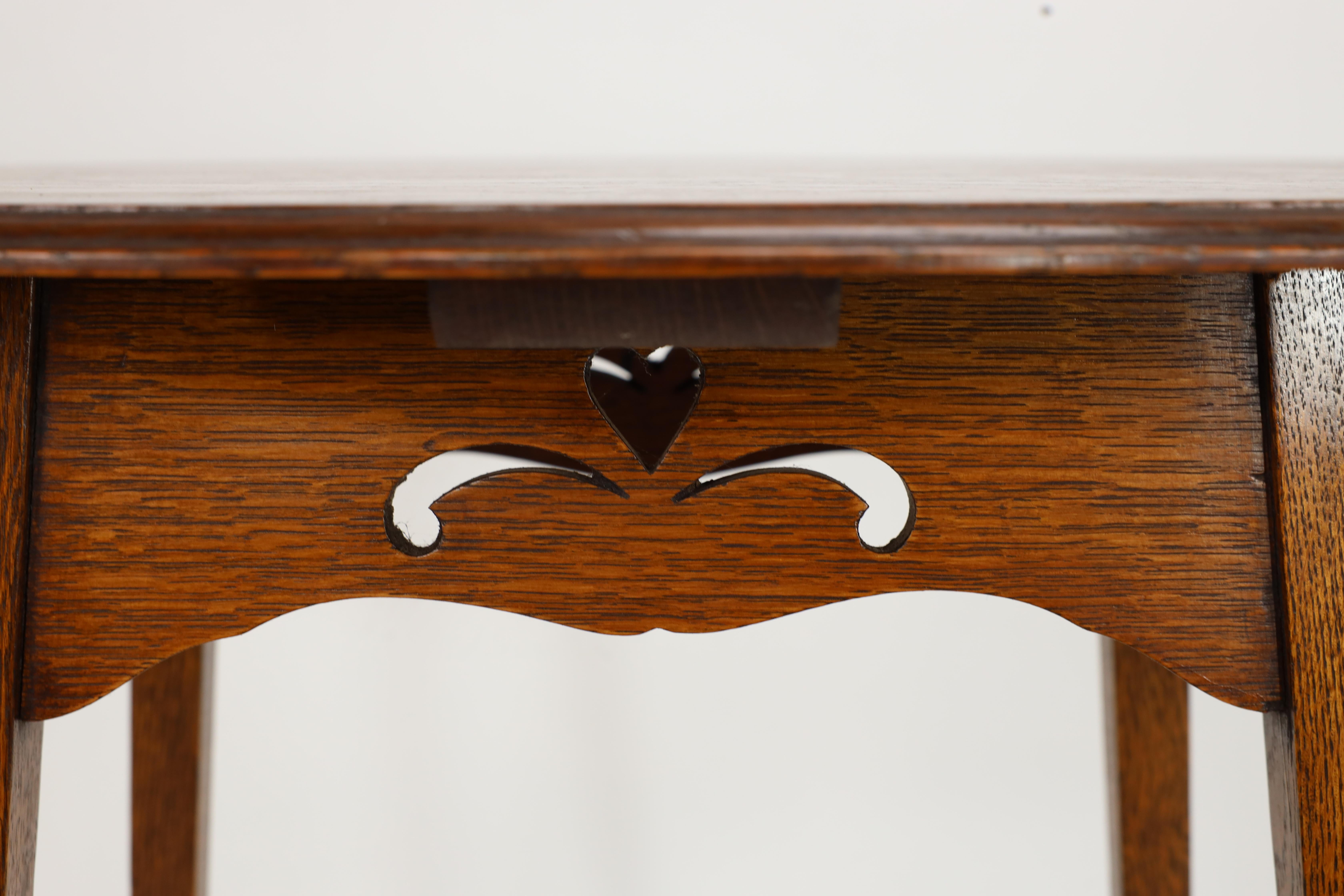 Liberty & Co. An Arts & Crafts oak oval top side table with heart cut-outs 8
