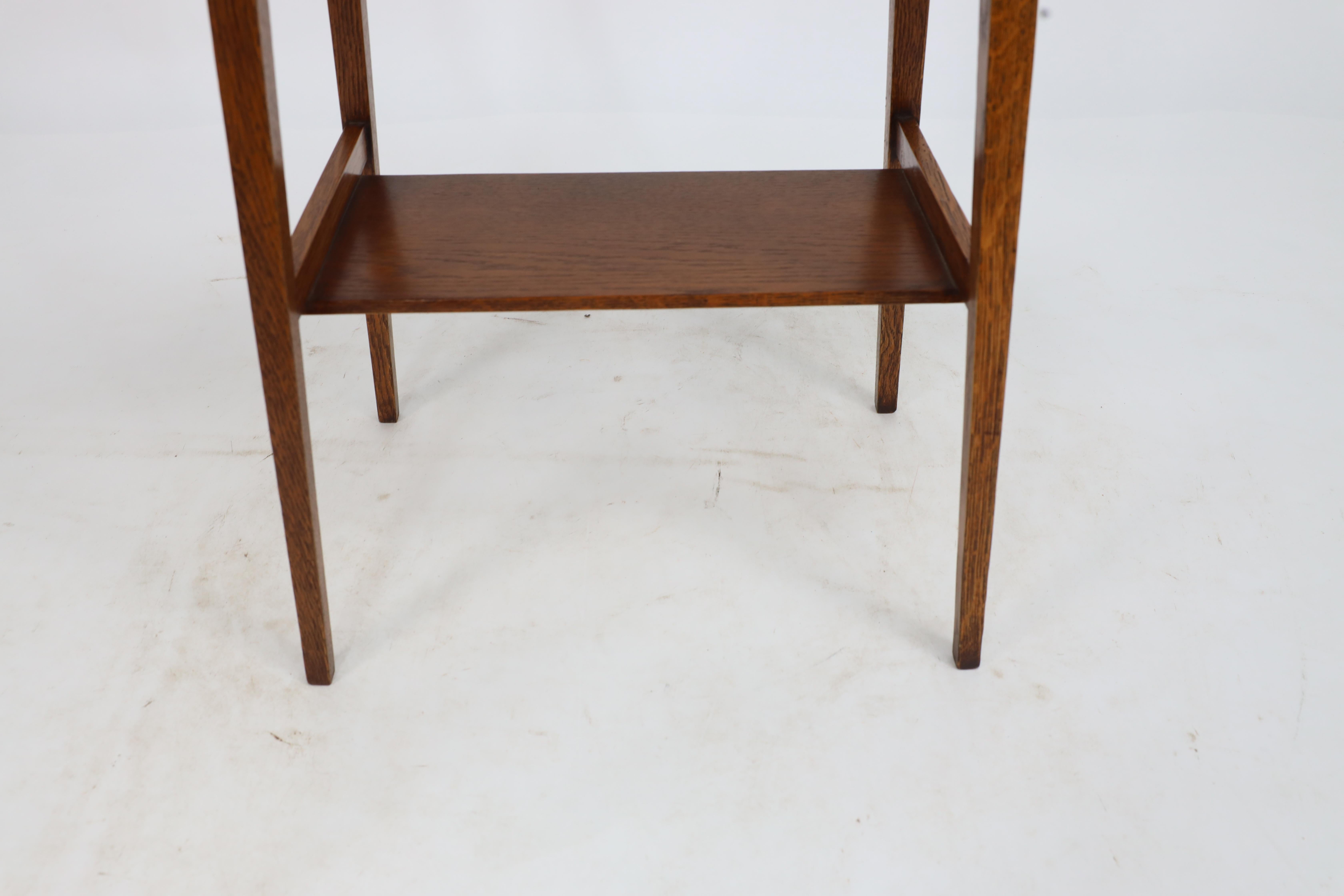 Liberty & Co. An Arts & Crafts oak oval top side table with heart cut-outs 12