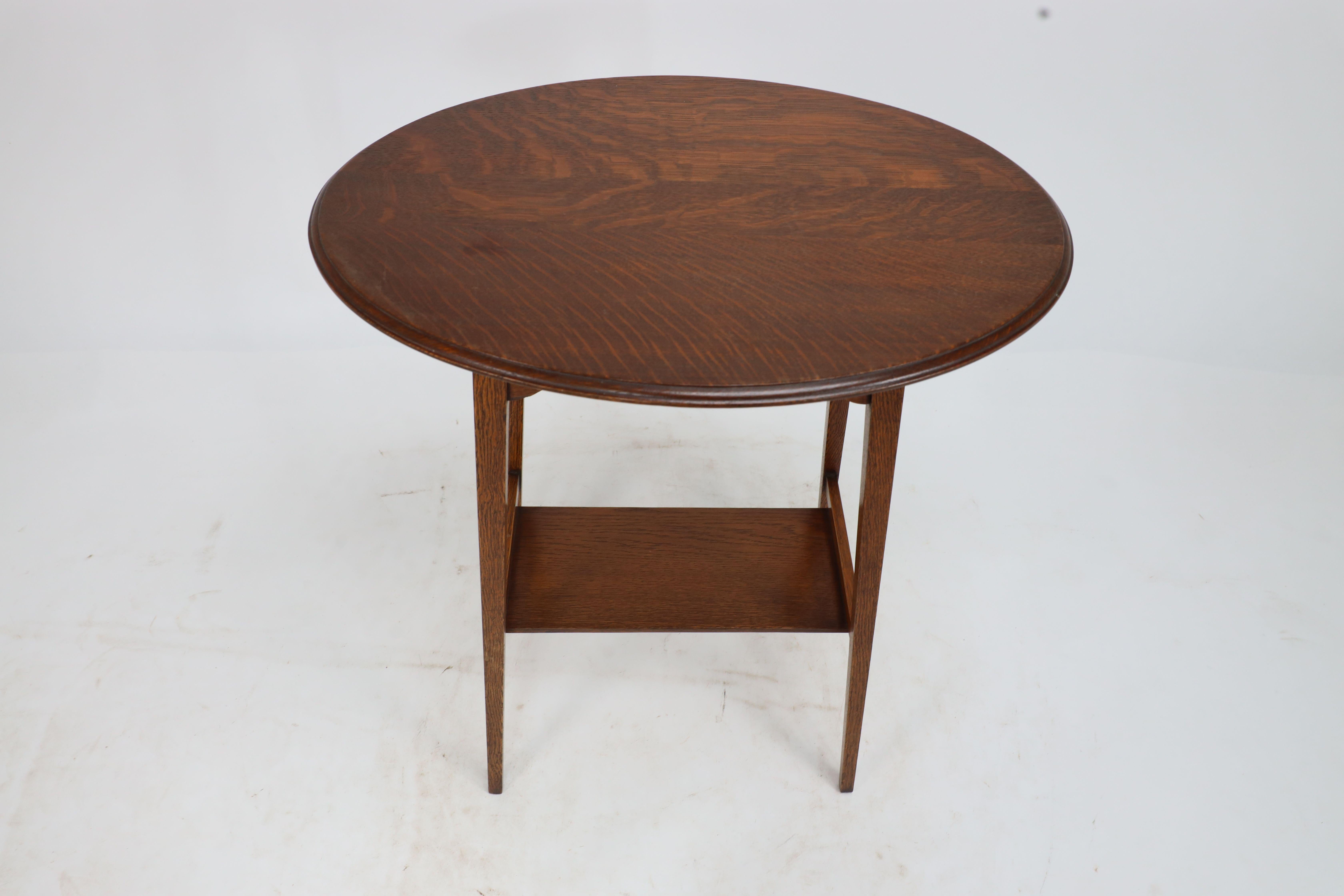 Liberty & Co. An Arts & Crafts oak oval top side table with heart cut-outs 2
