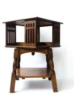 Liberty & Co an Arts & Crafts Oak Revolving Bookcase Table on Square Turned Legs