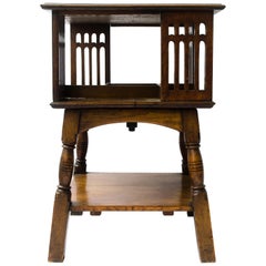 Liberty & Co an Arts & Crafts Oak Revolving Bookcase Table on Square Turned Legs