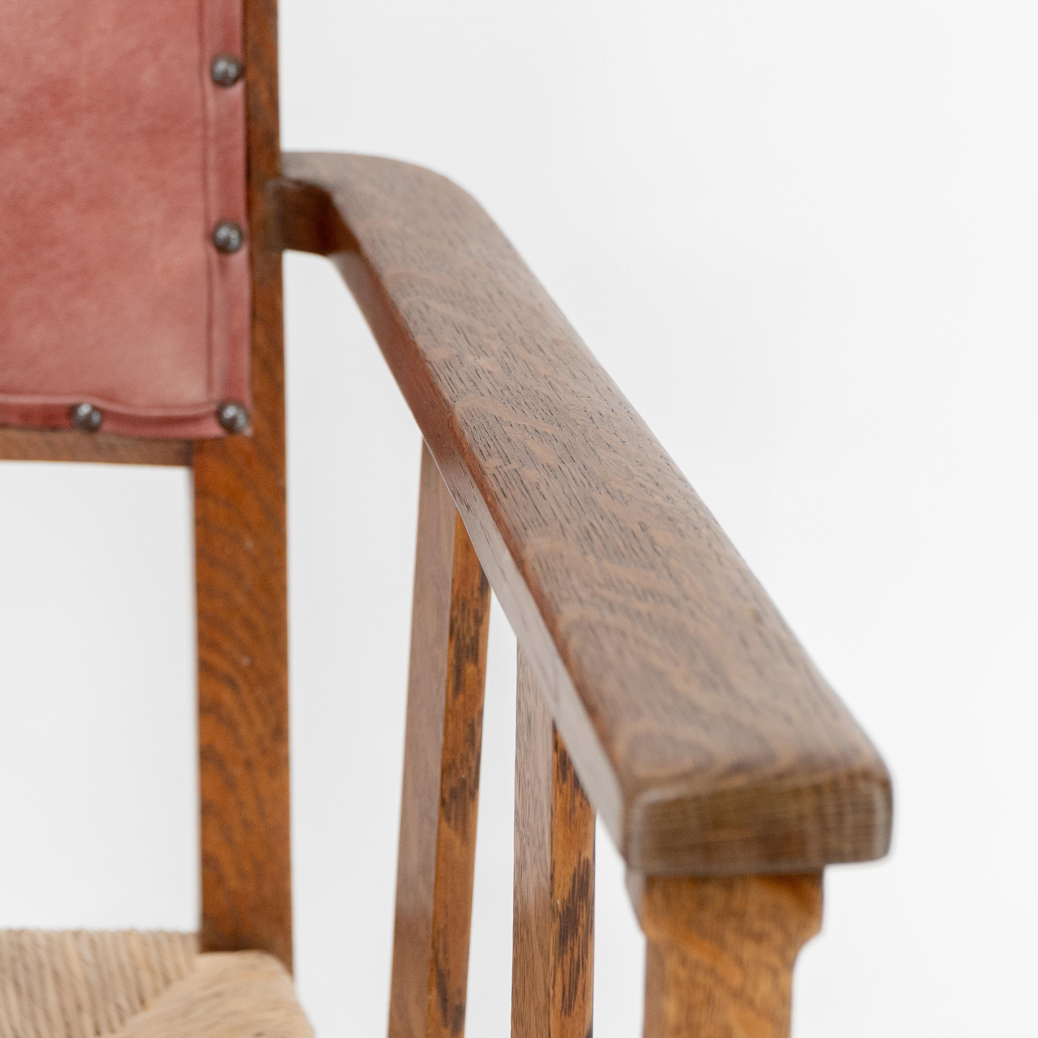 Liberty & Co. An Arts & Crafts rush seat armchair with a shaped back For Sale 3