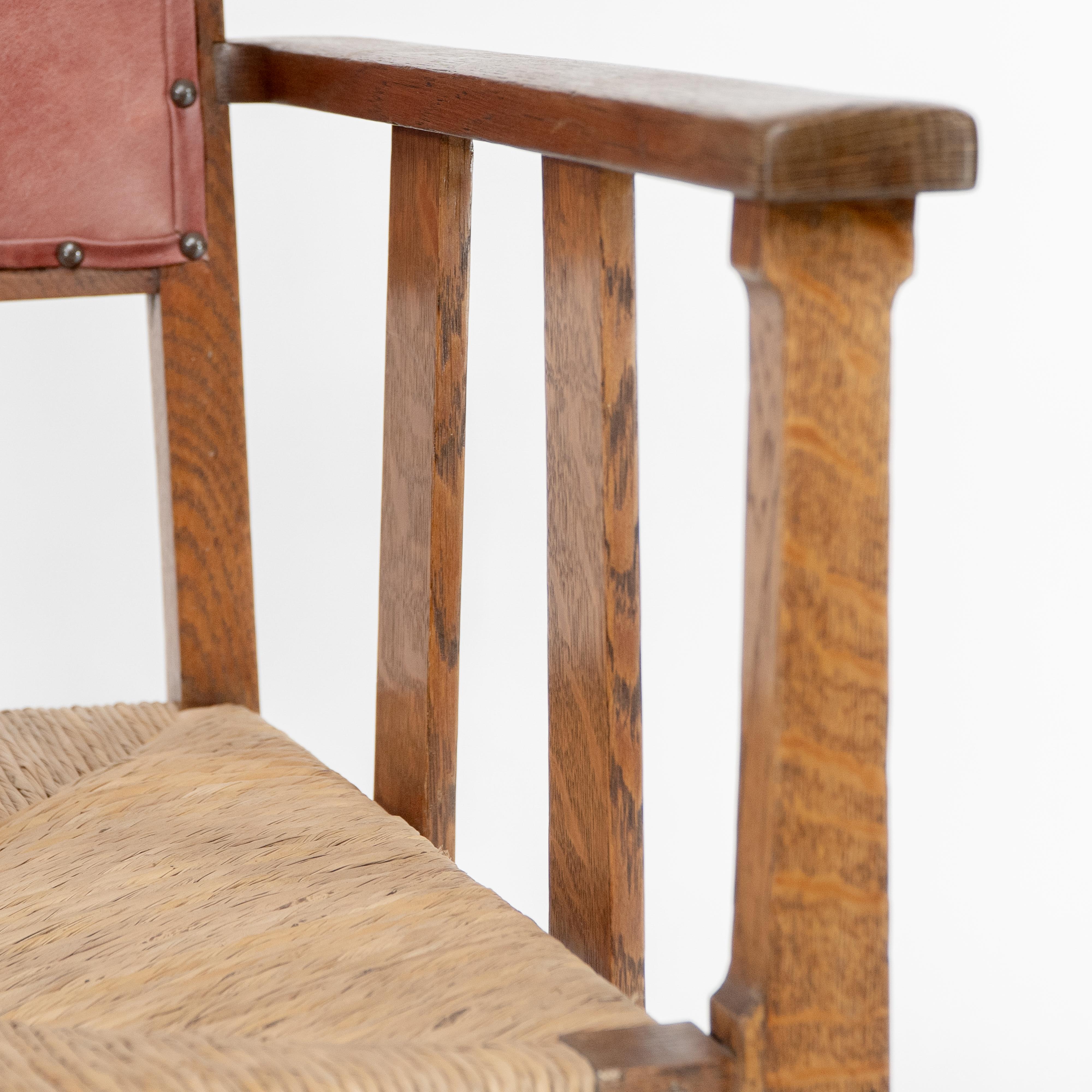 Liberty & Co. An Arts & Crafts rush seat armchair with a shaped back For Sale 4