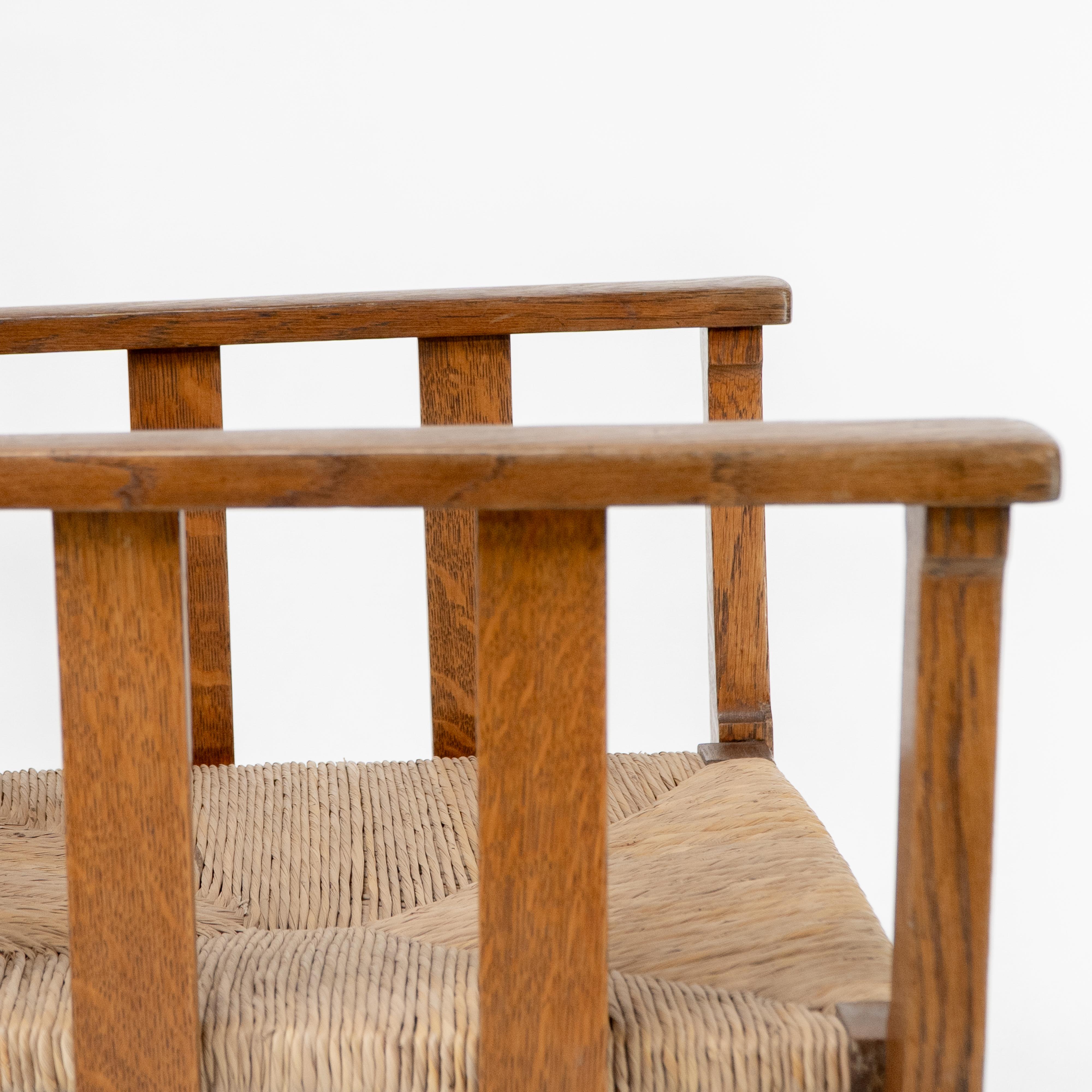 Liberty & Co. An Arts & Crafts rush seat armchair with a shaped back For Sale 9