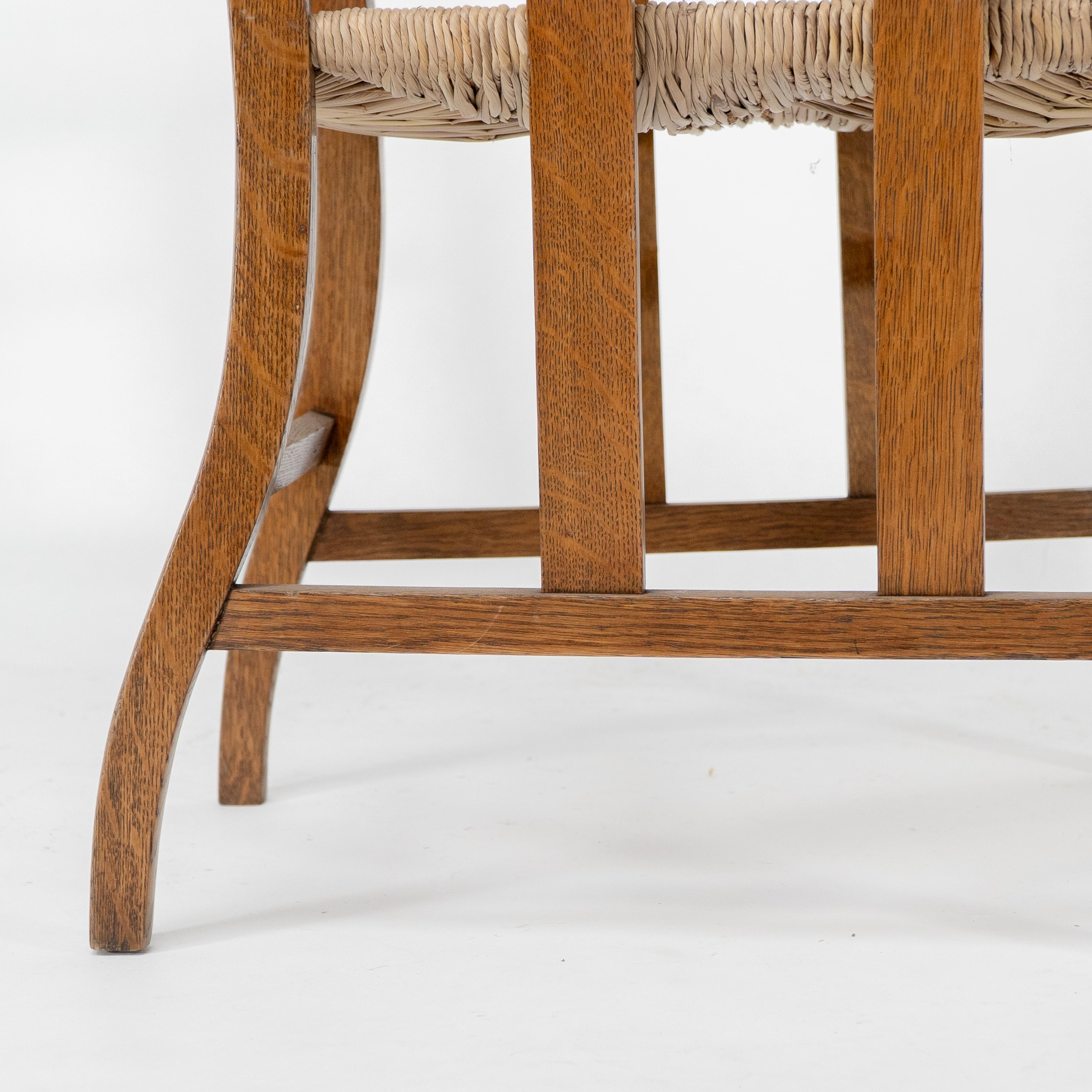 Liberty & Co. An Arts & Crafts rush seat armchair with a shaped back For Sale 10