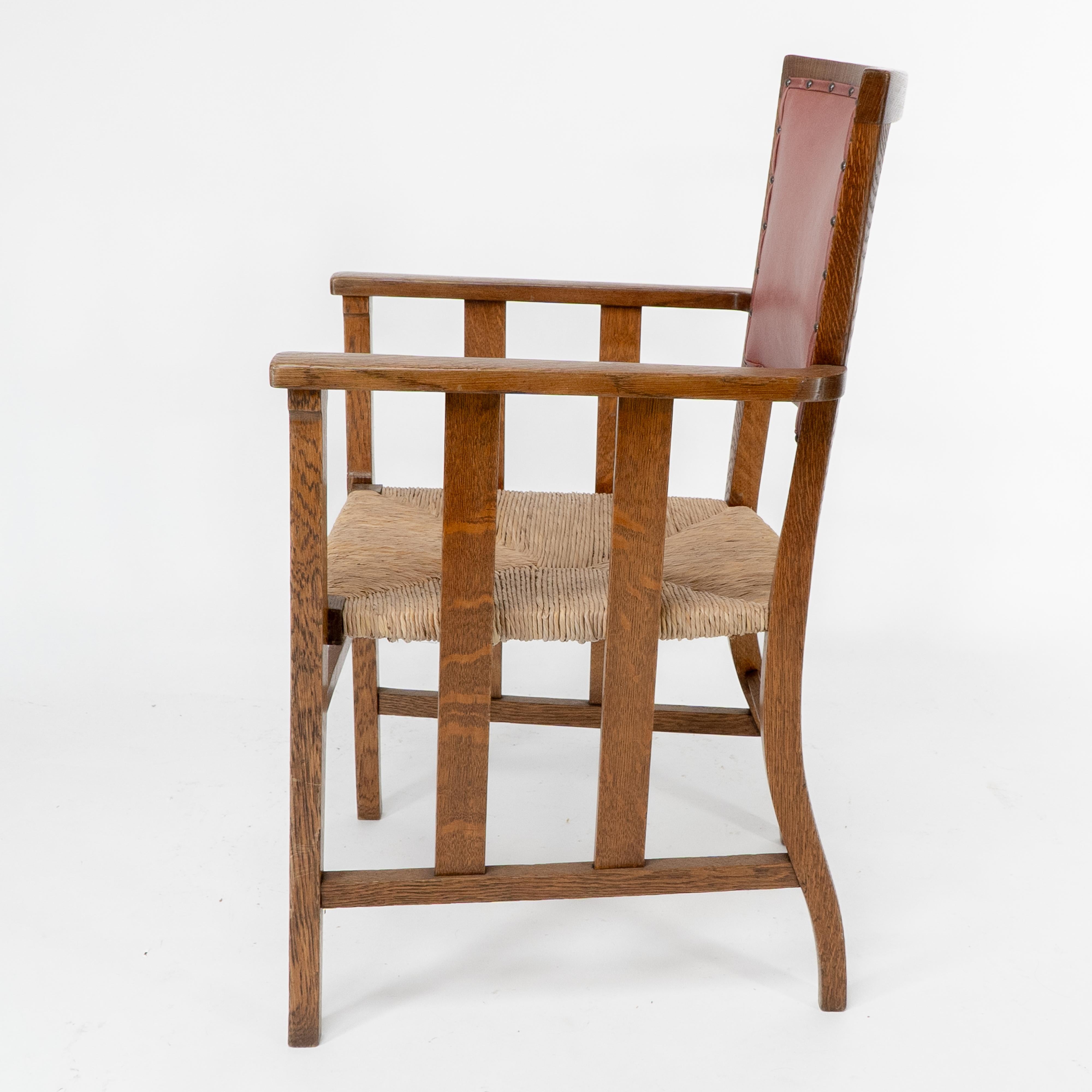 Liberty & Co. An Arts & Crafts rush seat armchair with a shaped back In Good Condition For Sale In London, GB