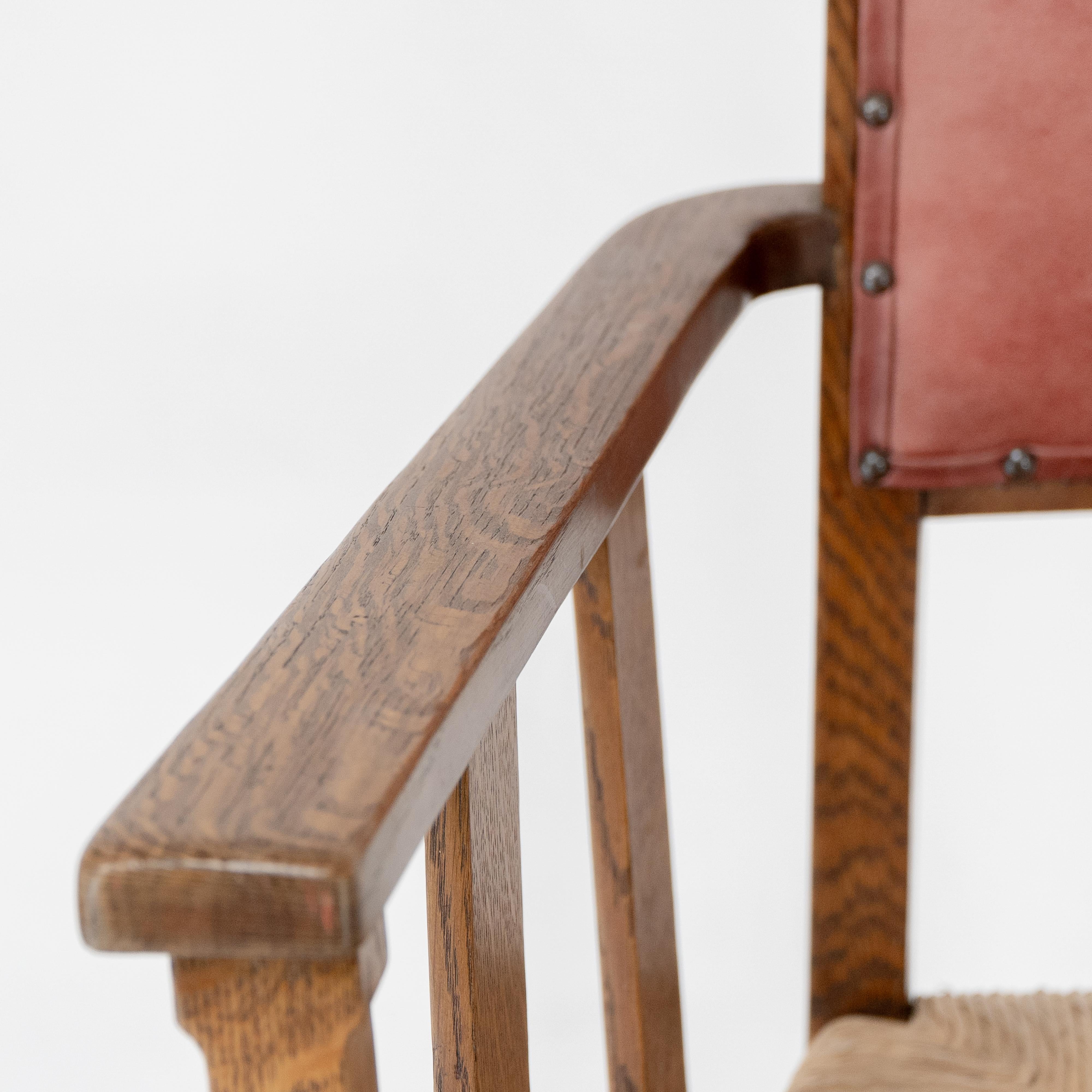 Liberty & Co. An Arts & Crafts rush seat armchair with a shaped back For Sale 1