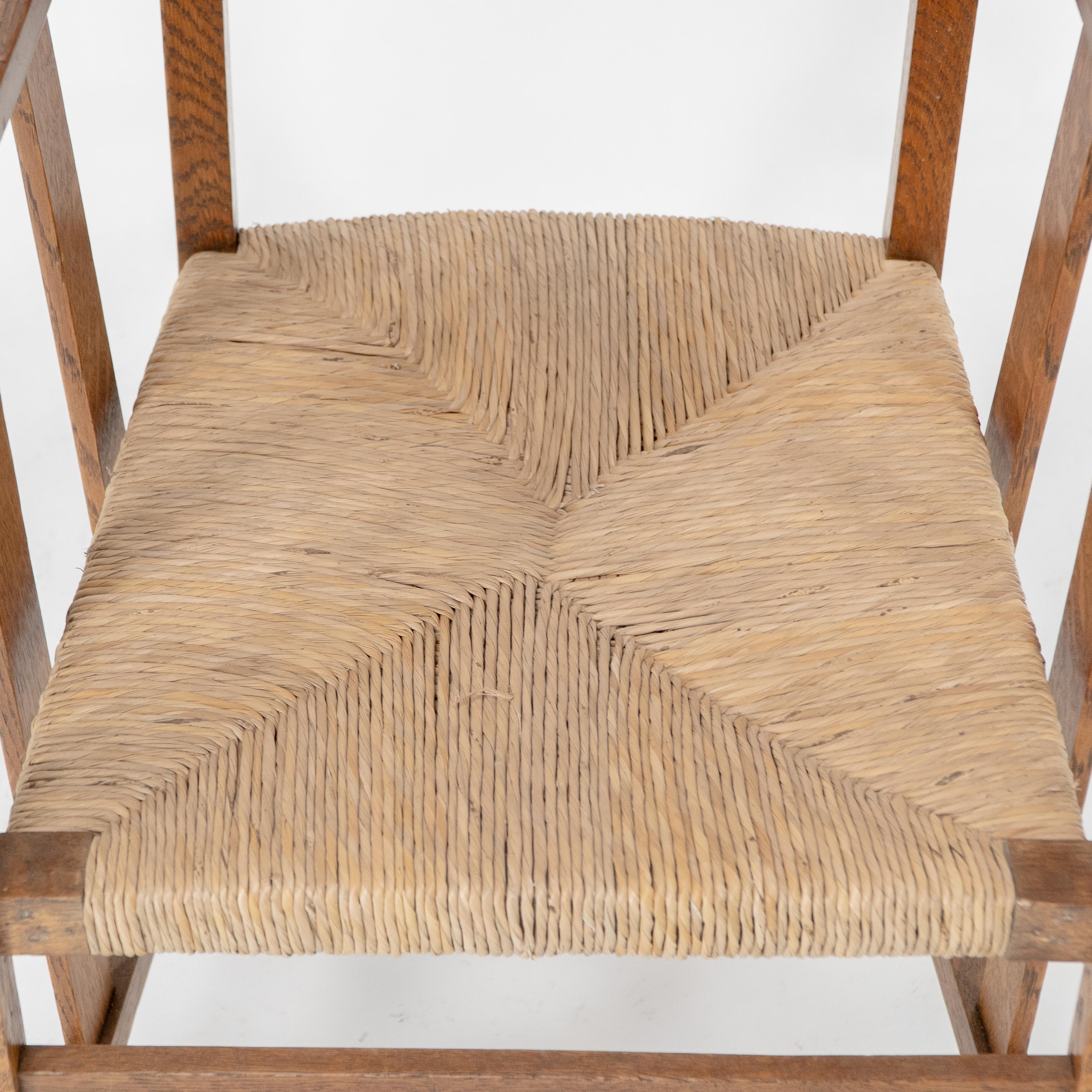 Liberty & Co. An Arts & Crafts rush seat armchair with a shaped back For Sale 2