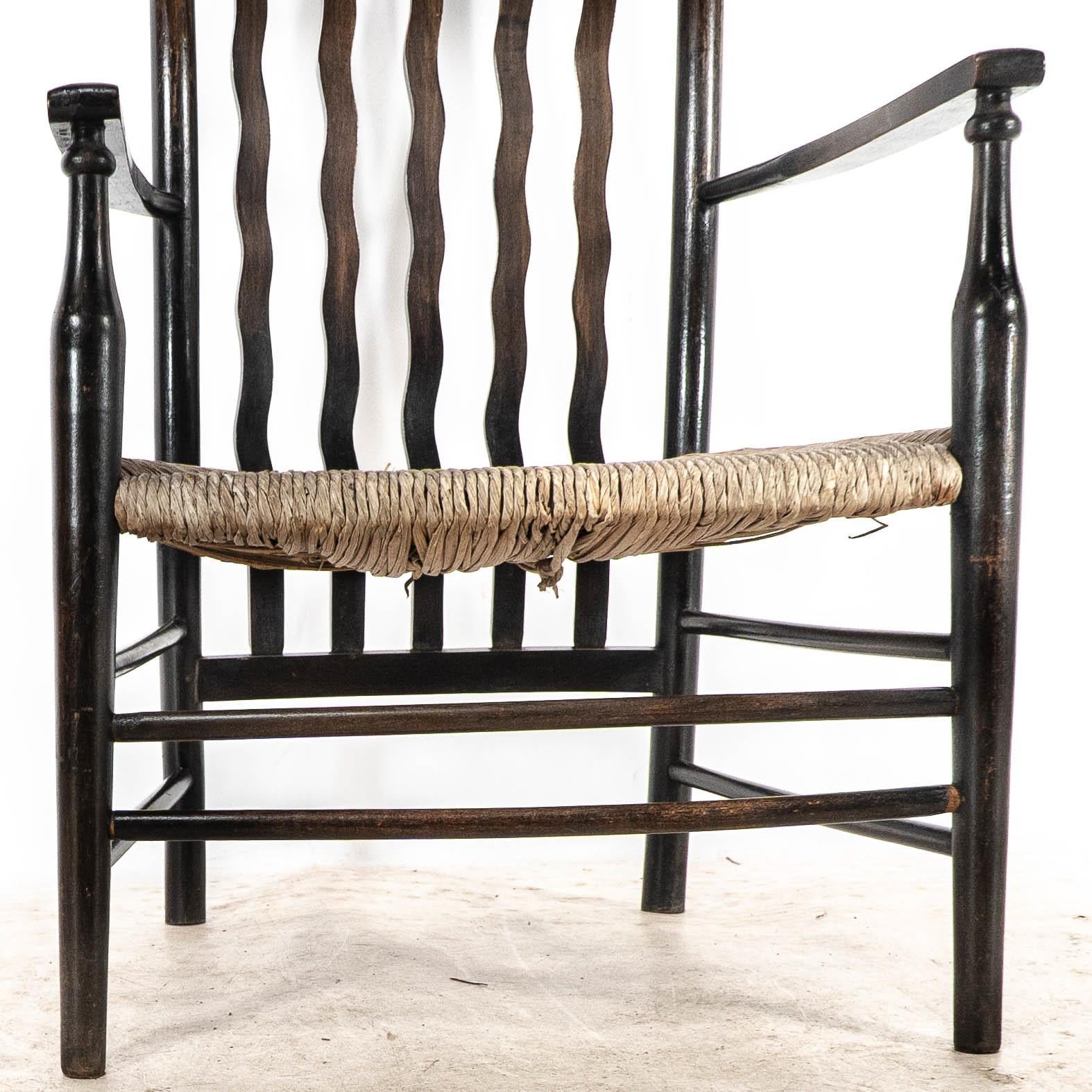 Liberty & Co. An Arts & Crafts rush seat armchair with wavy shaped back slats For Sale 5