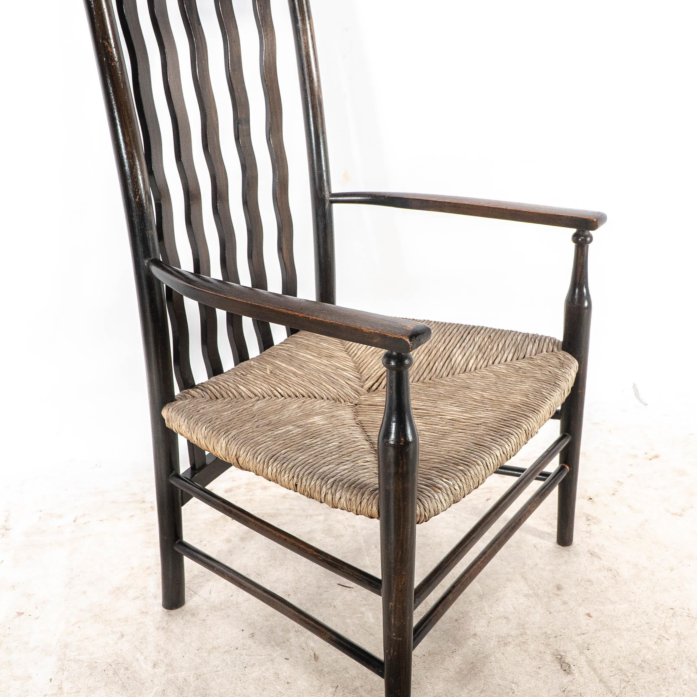 Liberty & Co. An Arts & Crafts rush seat armchair with wavy shaped back slats For Sale 6