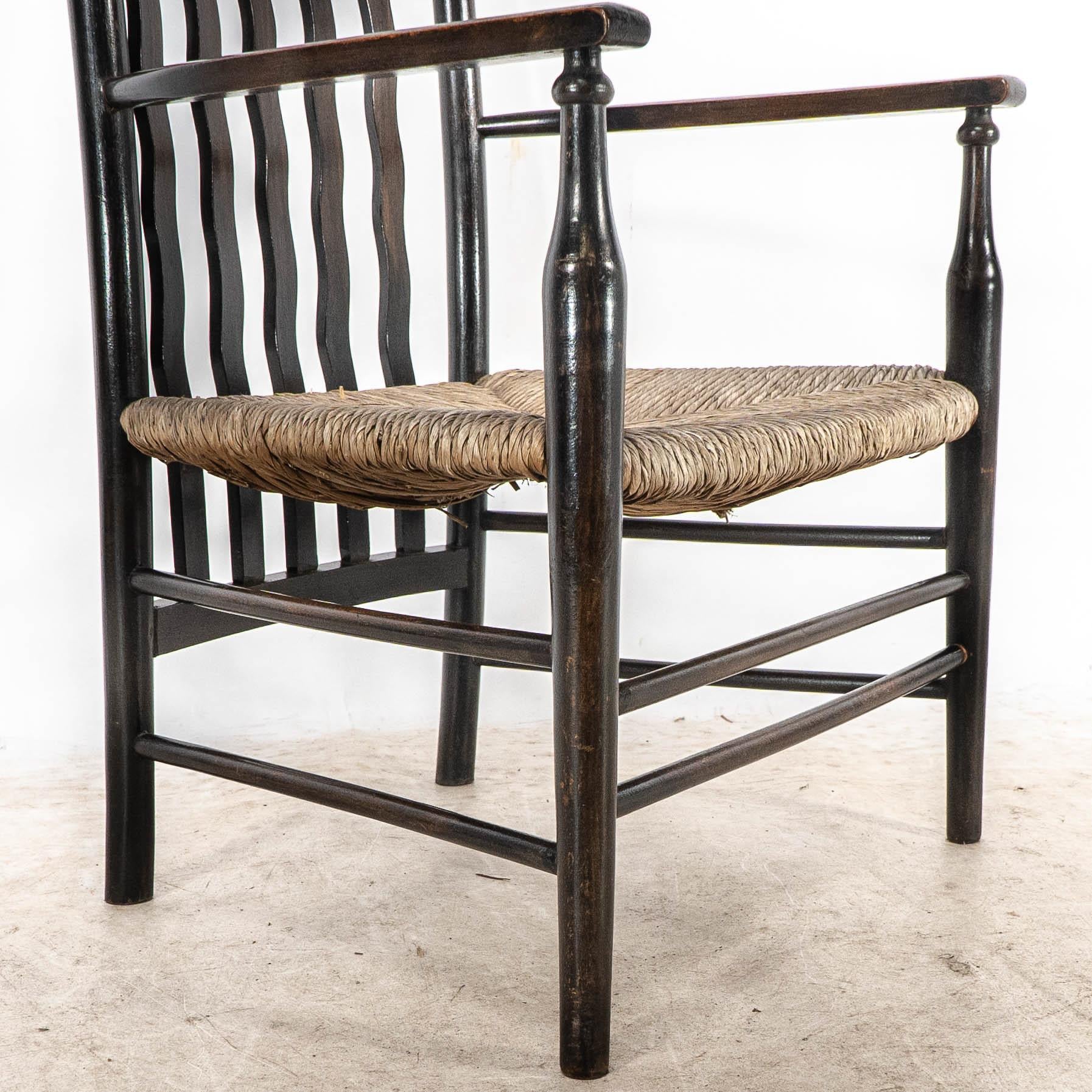 Liberty & Co. An Arts & Crafts rush seat armchair with wavy shaped back slats For Sale 7