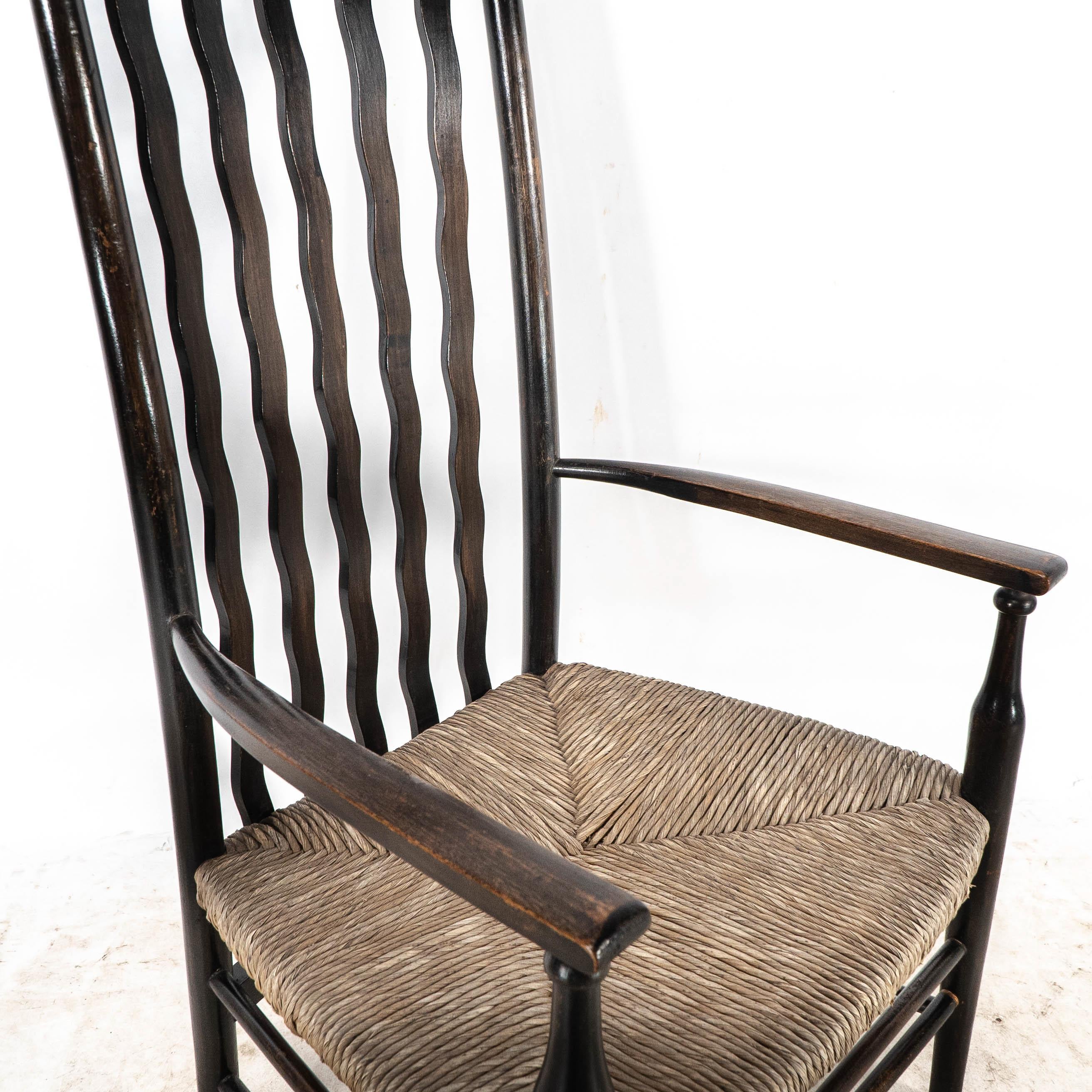 Liberty & Co. An Arts & Crafts rush seat armchair with wavy shaped back slats For Sale 8