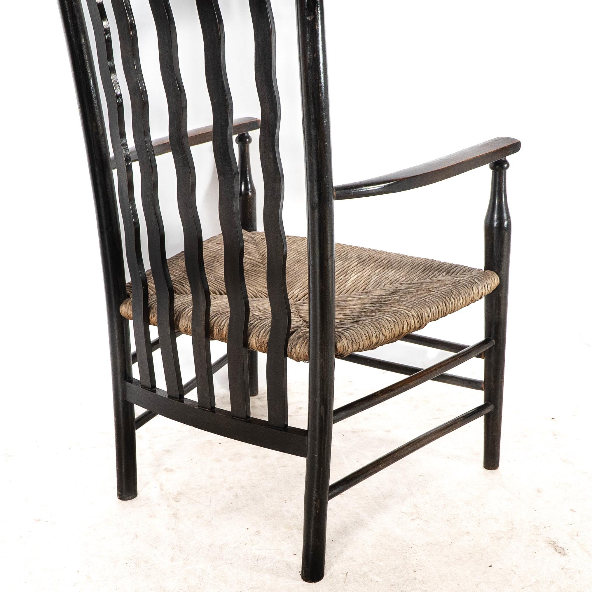 Liberty & Co. An Arts & Crafts rush seat armchair with wavy shaped back slats For Sale 10