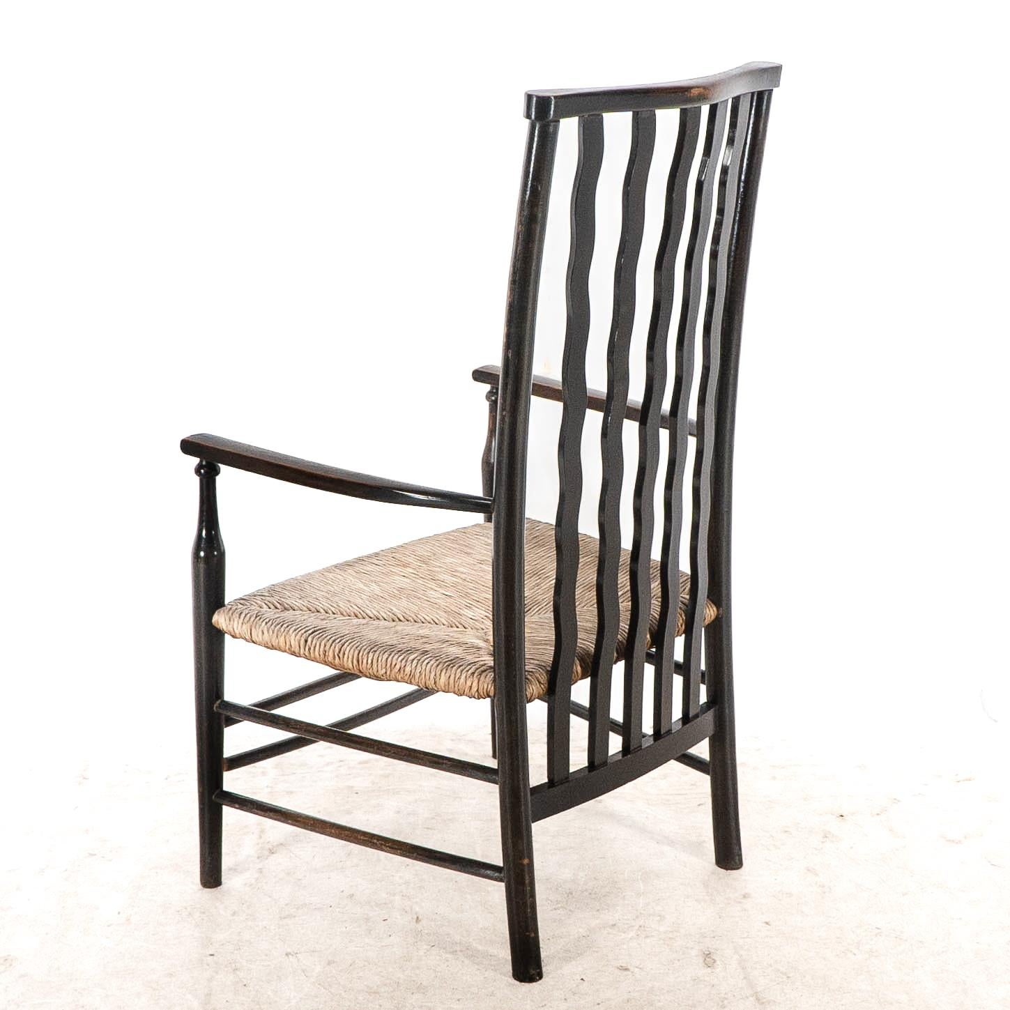 Liberty & Co. An Arts & Crafts rush seat armchair with wavy shaped back slats For Sale 11