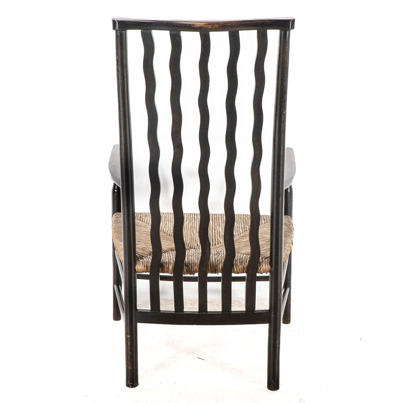 Liberty & Co. An Arts & Crafts rush seat armchair with wavy shaped back slats For Sale 12