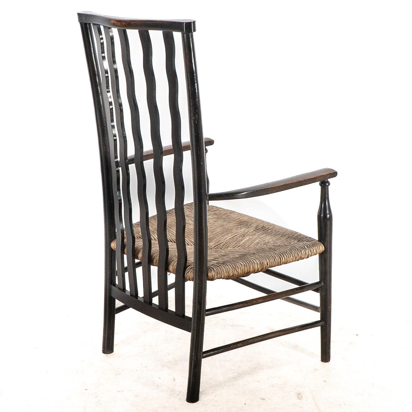 Liberty & Co. An Arts & Crafts rush seat armchair with wavy shaped back slats For Sale 13