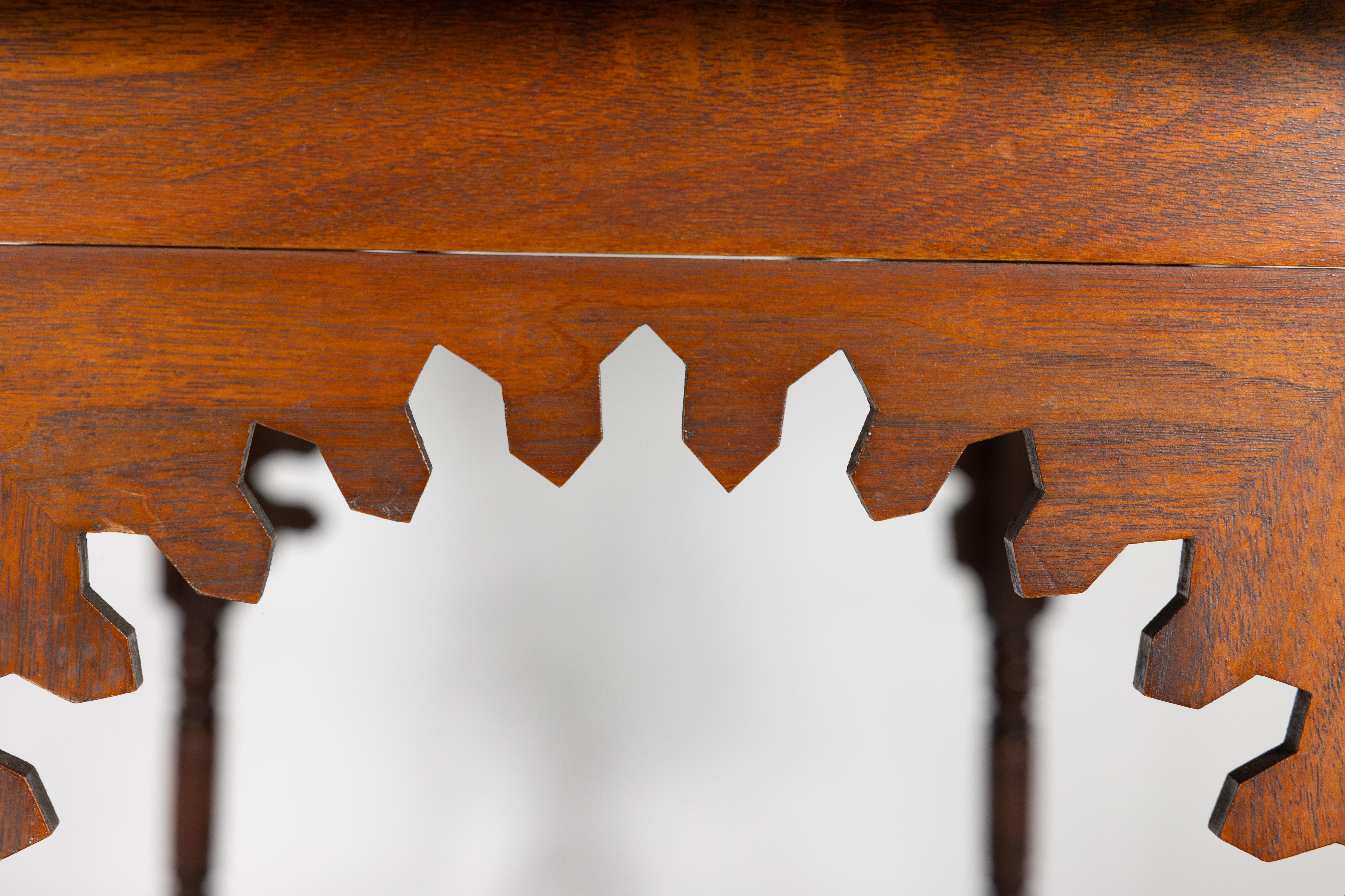 Liberty & Co. An Arts & Crafts walnut centre table with arched aprons 1