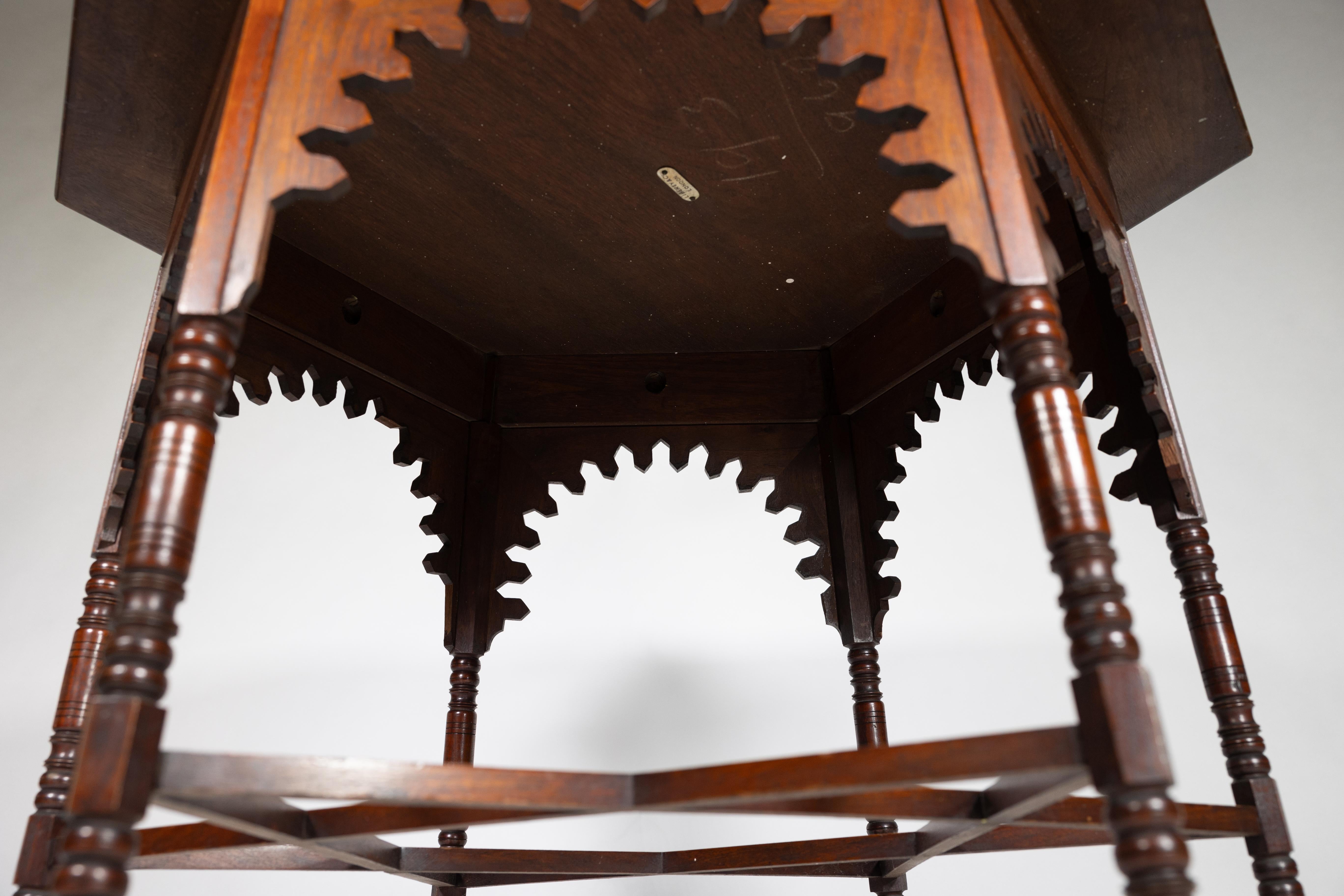 Liberty & Co. An Arts & Crafts walnut centre table with arched aprons 3