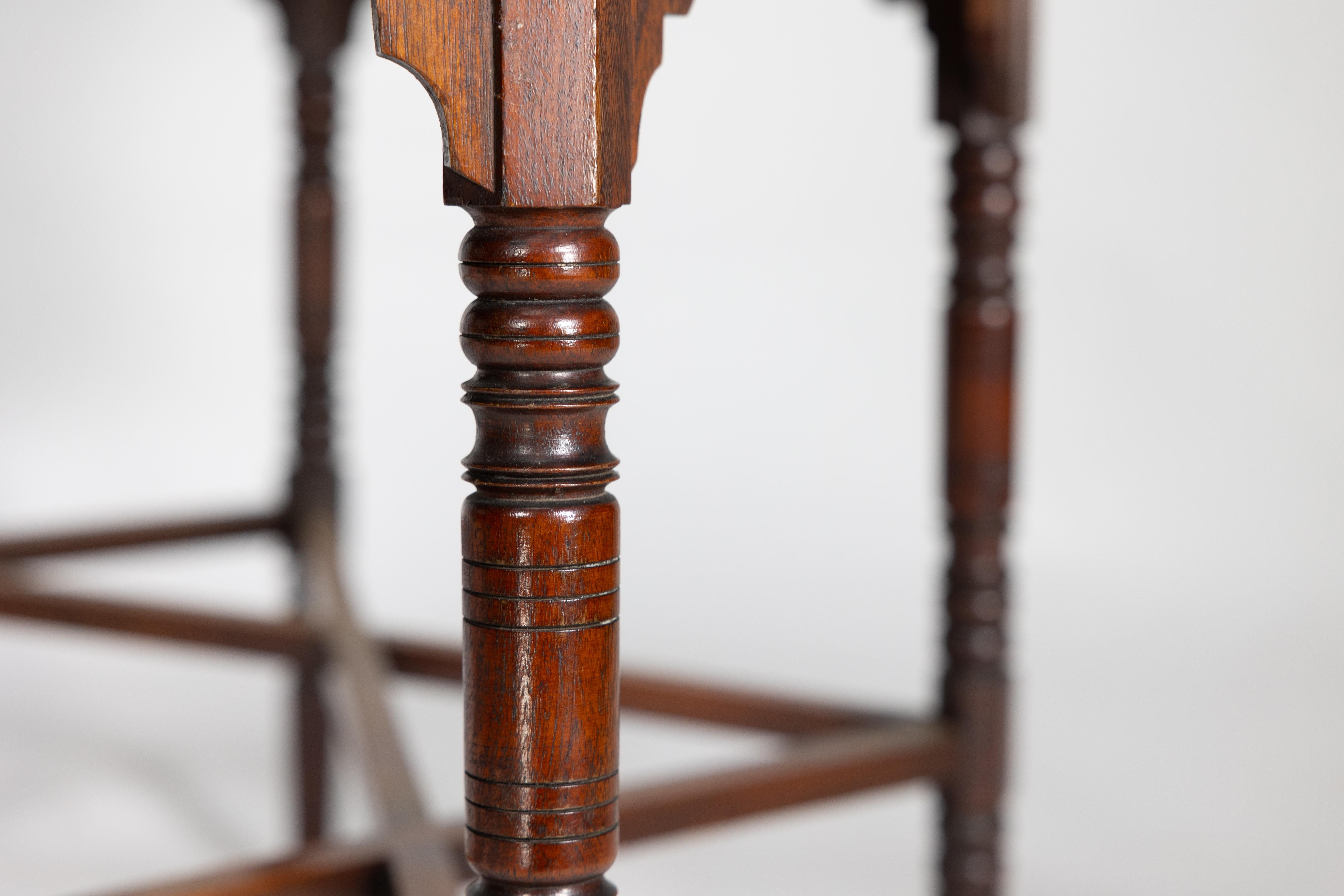 Liberty & Co. An Arts & Crafts walnut centre table with arched aprons 4