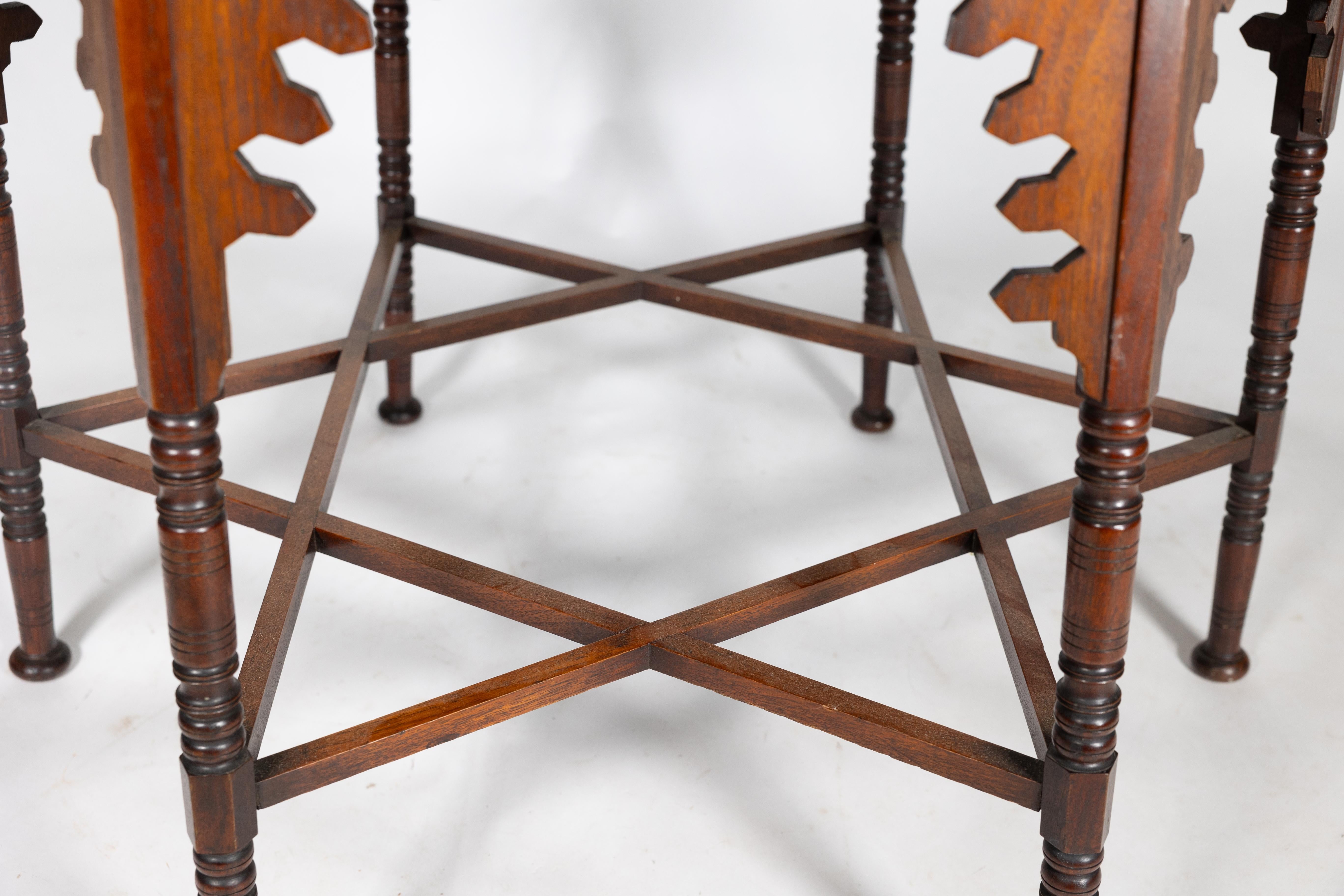 Liberty & Co. An Arts & Crafts walnut centre table with arched aprons 5