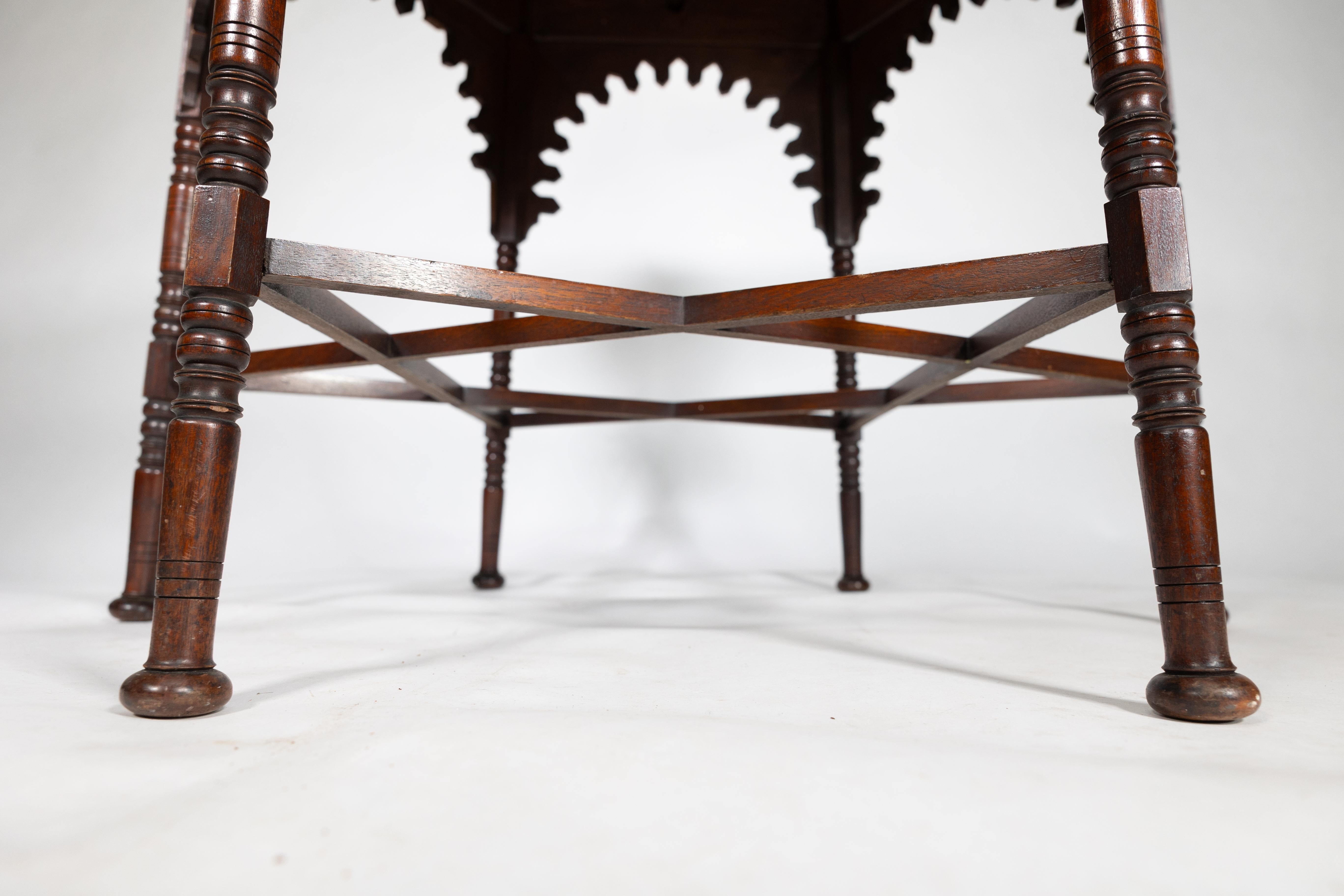 Liberty & Co. An Arts & Crafts walnut centre table with arched aprons 7