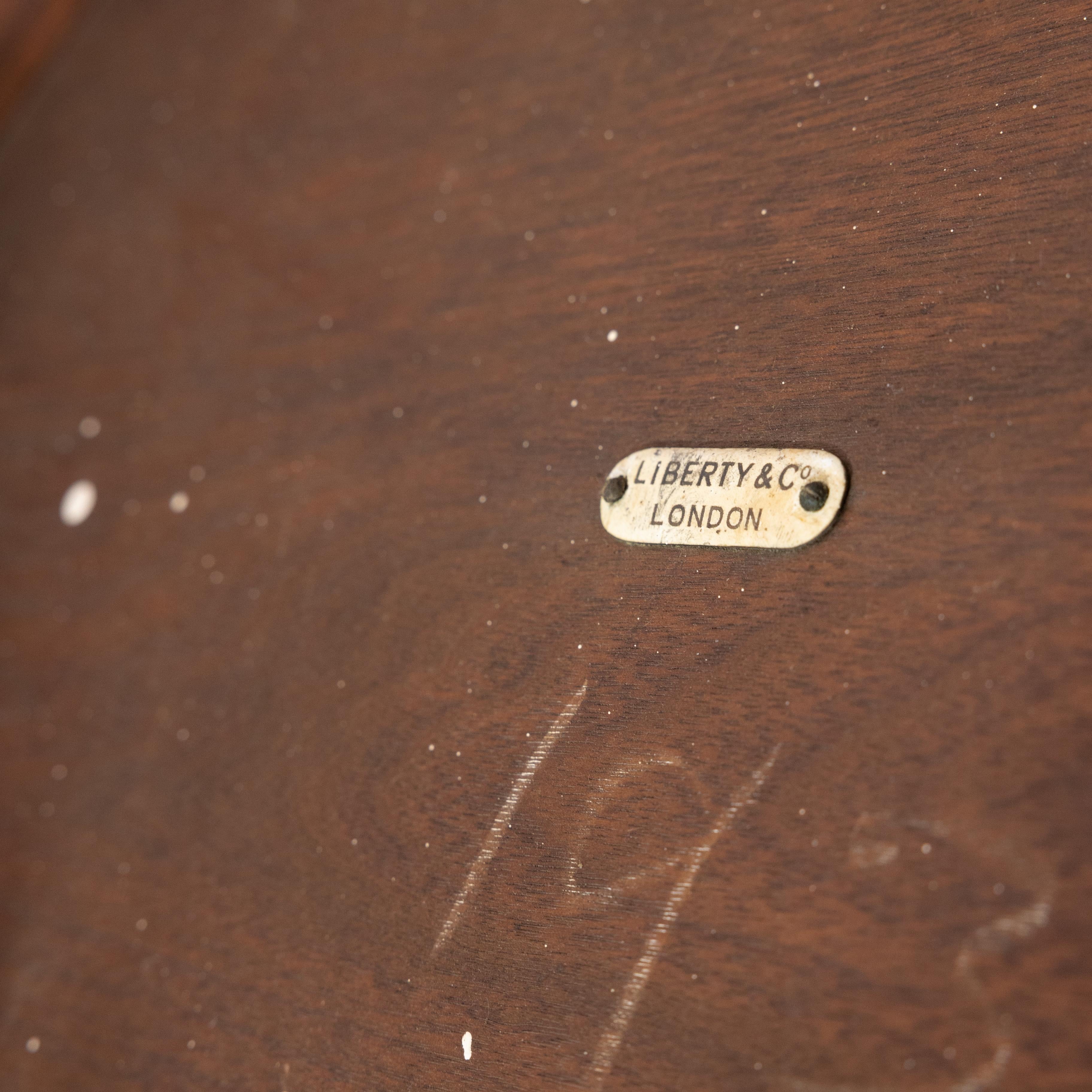 Liberty & Co. An Arts & Crafts walnut centre table with arched aprons 8