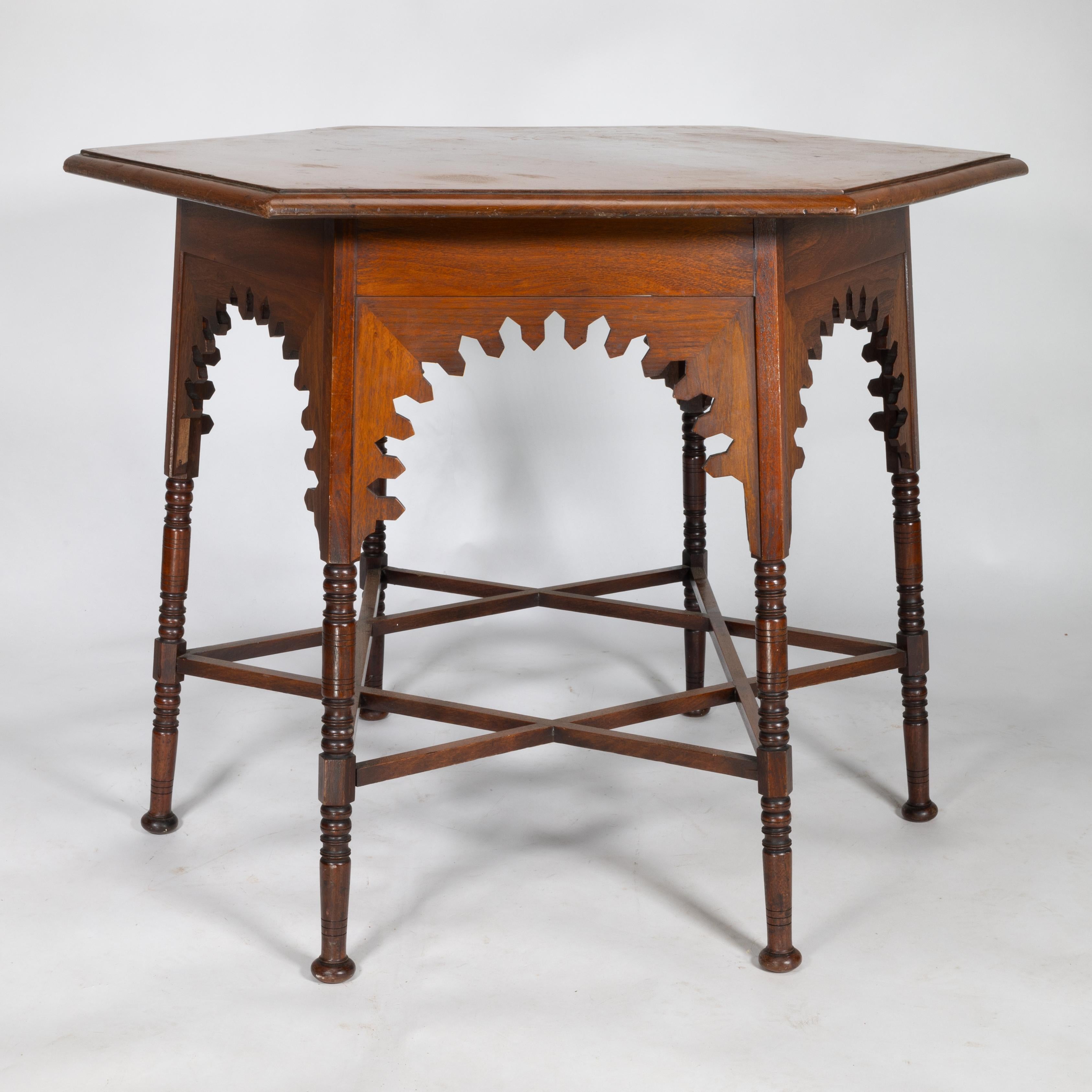 Arts and Crafts Liberty & Co. An Arts & Crafts walnut centre table with arched aprons For Sale