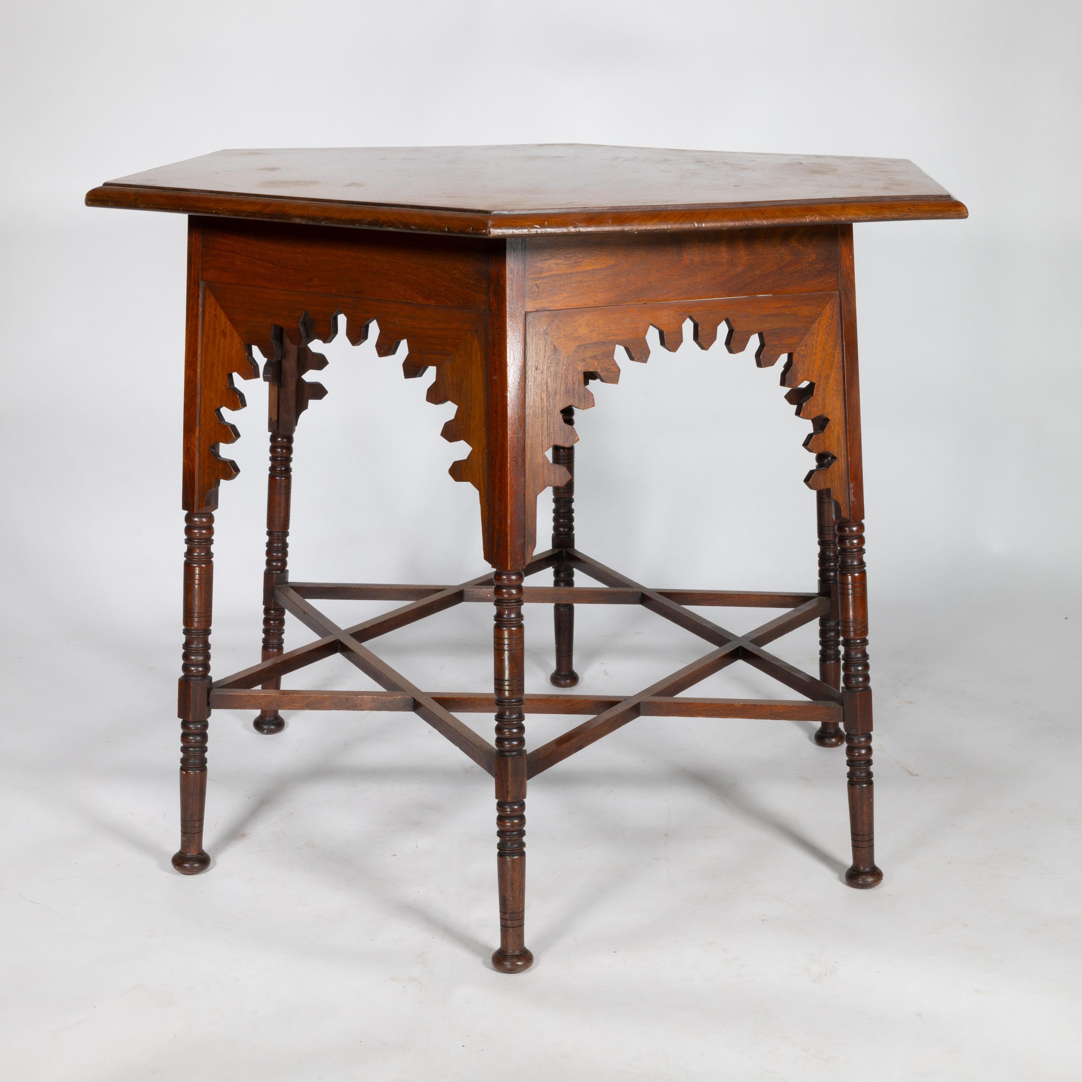 French Liberty & Co. An Arts & Crafts walnut centre table with arched aprons For Sale