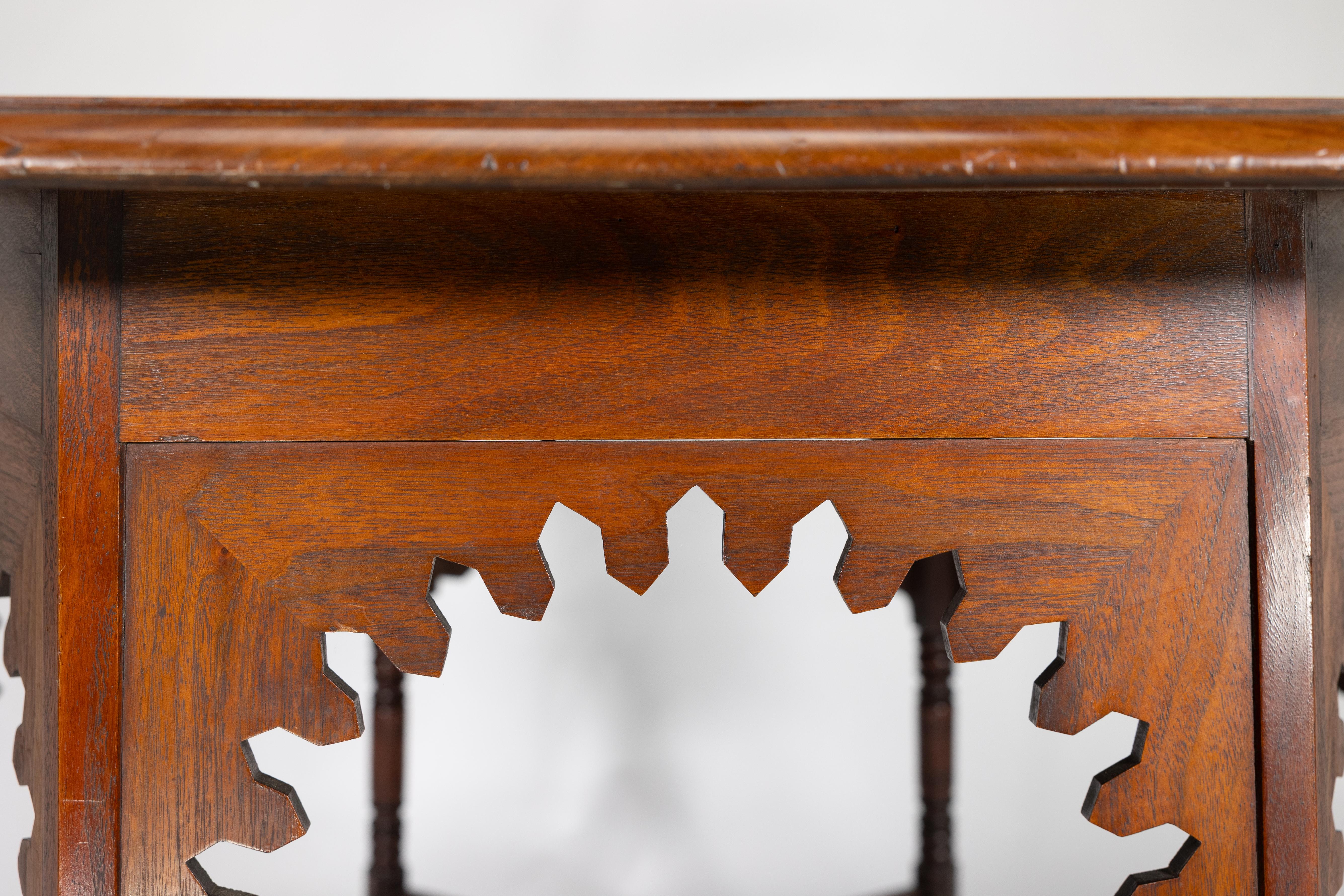 Walnut Liberty & Co. An Arts & Crafts walnut centre table with arched aprons