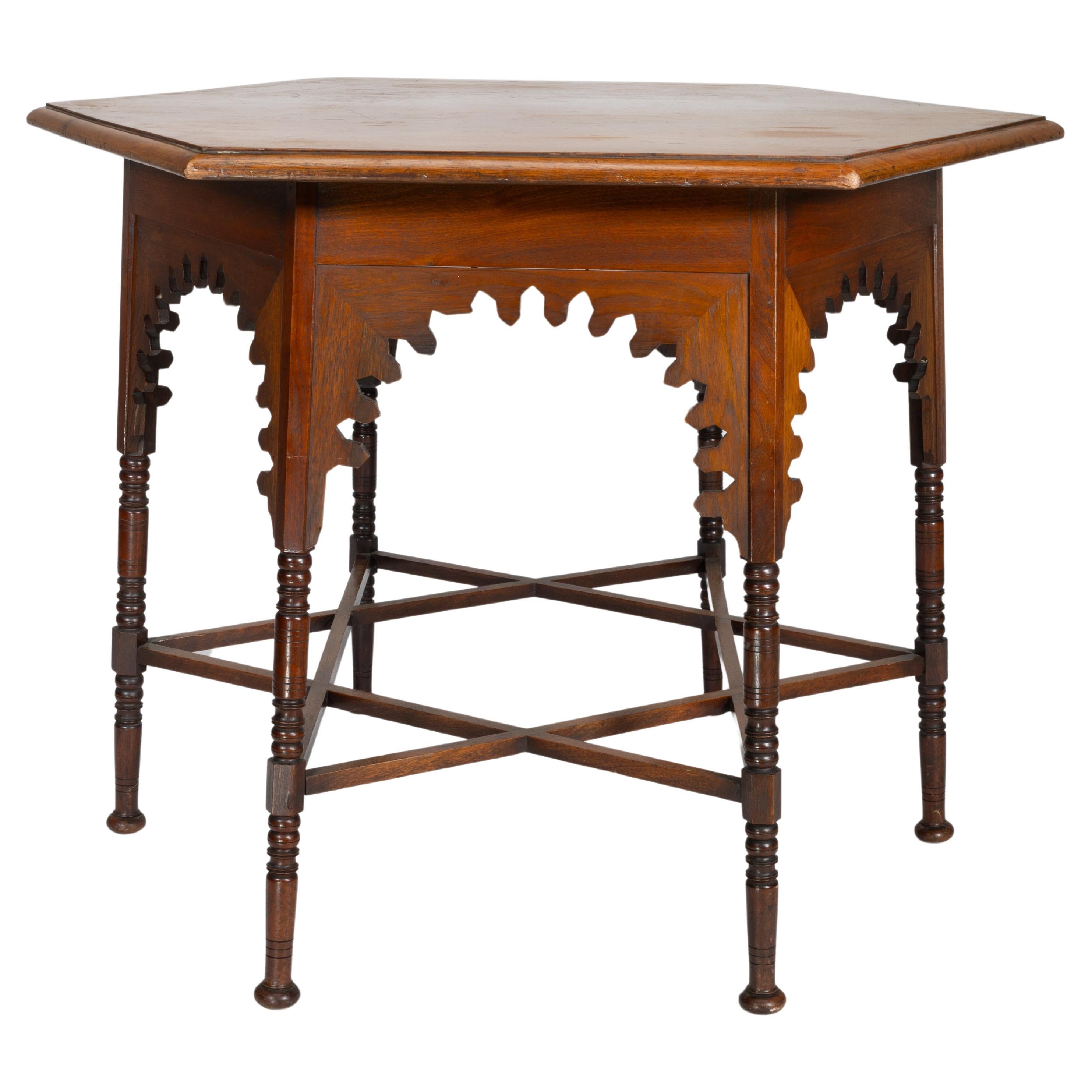 Liberty & Co. An Arts & Crafts walnut centre table with arched aprons For Sale