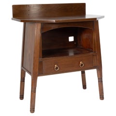 Antique Liberty & Co. An Arts & Crafts walnut side cabinet in the style of Morris & Co.