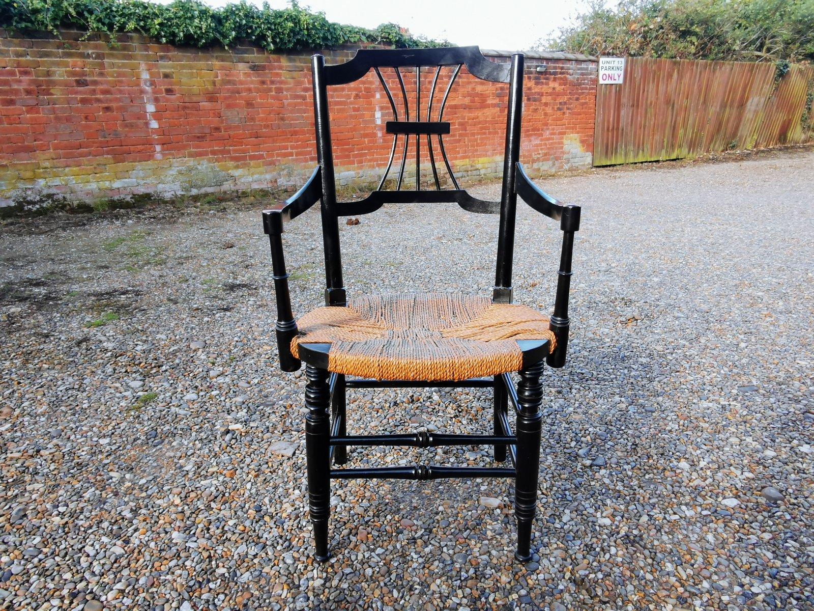 Ebonized Liberty & Co. an English Aesthetic Movement Ebonised Armchair with Seagrass Seat For Sale