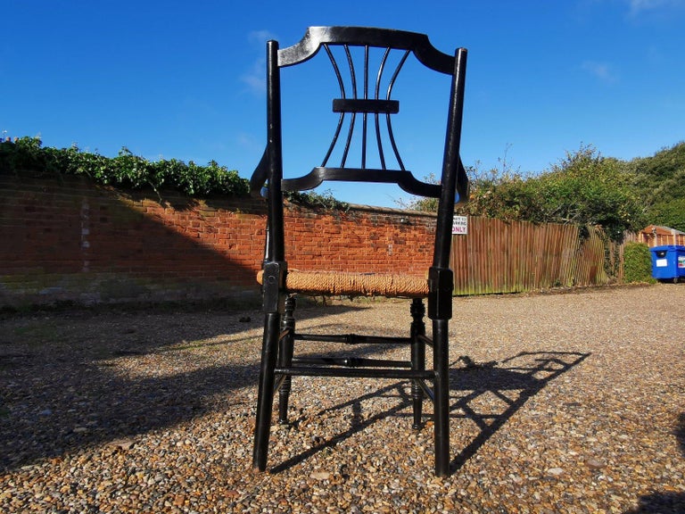 Liberty & Co. an English Aesthetic Movement Ebonised Armchair with Seagrass Seat In Good Condition For Sale In London, GB