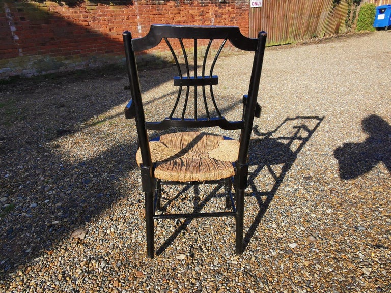 19th Century Liberty & Co. an English Aesthetic Movement Ebonised Armchair with Seagrass Seat For Sale