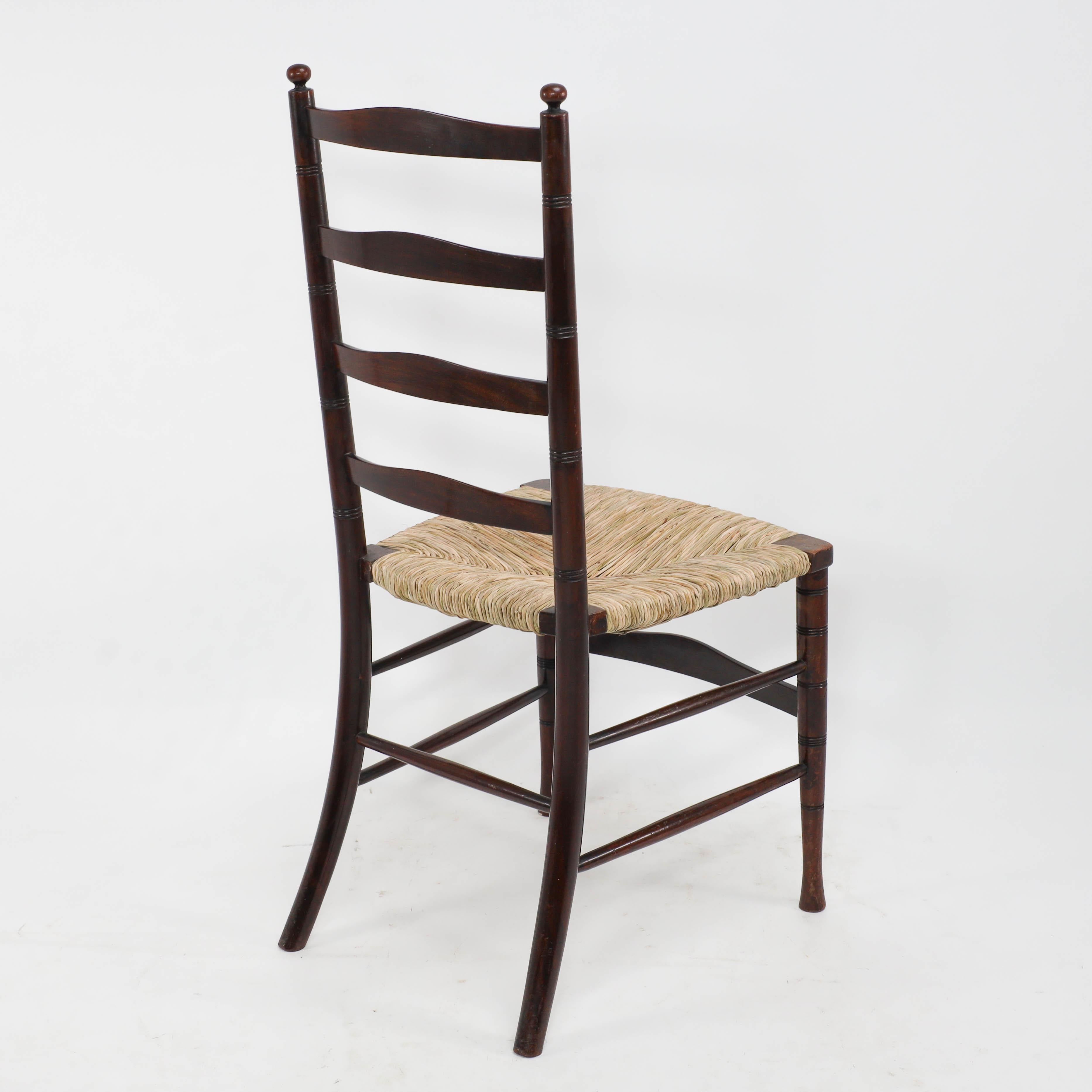Liberty & Co. An English Aesthetic Movement walnut ladder back rush seat chair For Sale 3