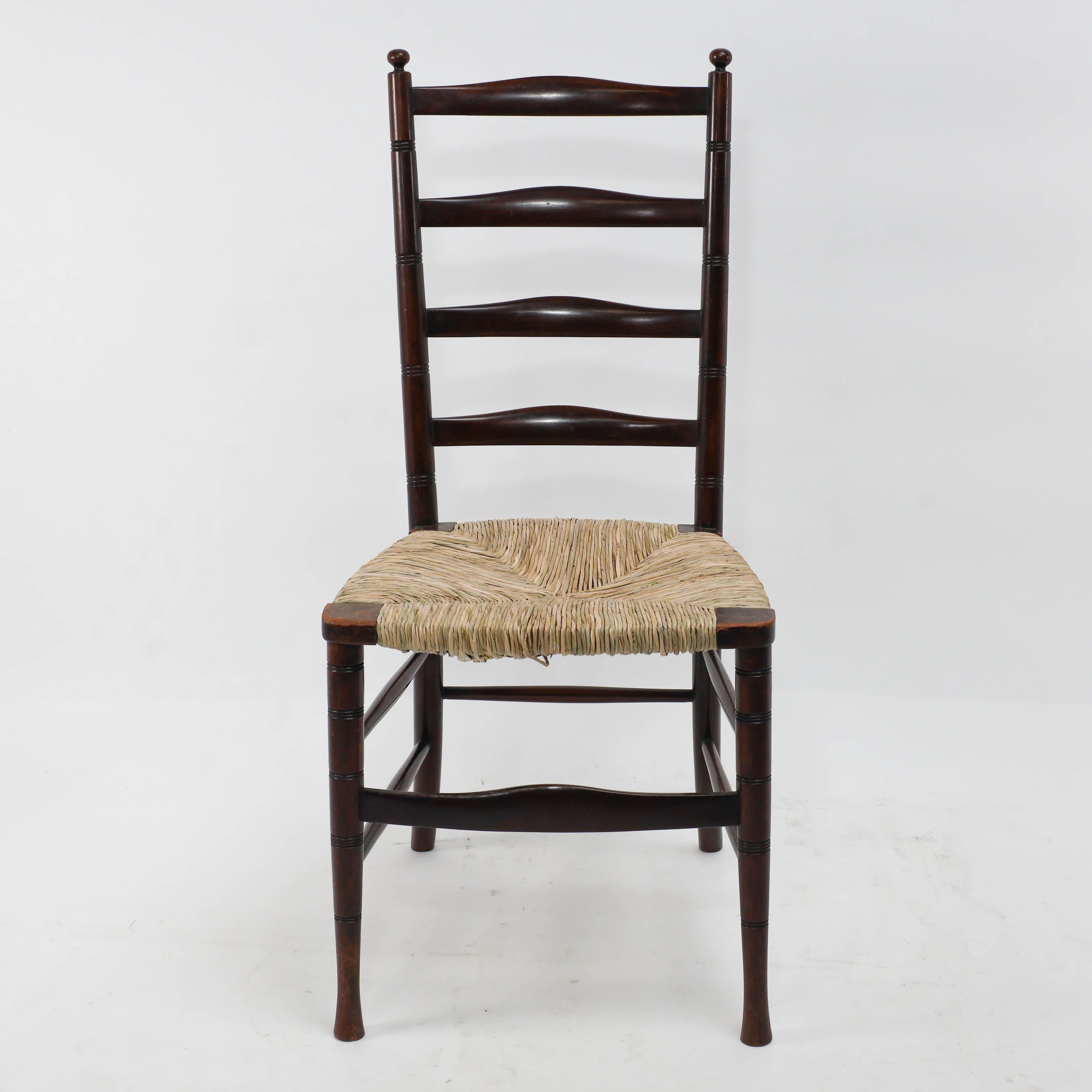 Liberty and Co. London. 
An elegant English Aesthetic Movement walnut ladder back side chair. 
The last three images are from: A Pictorial Dictionary of British 19th Century Furniture Design. They show slight variations in this design.
With