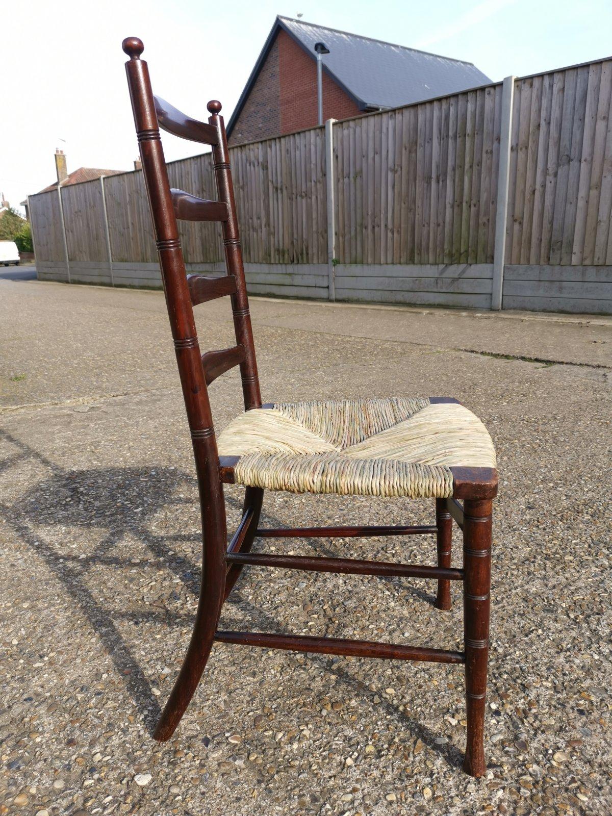 Arts and Crafts Liberty & Co. An English Aesthetic Movement Walnut Ladder Back Rush Seat Chair For Sale
