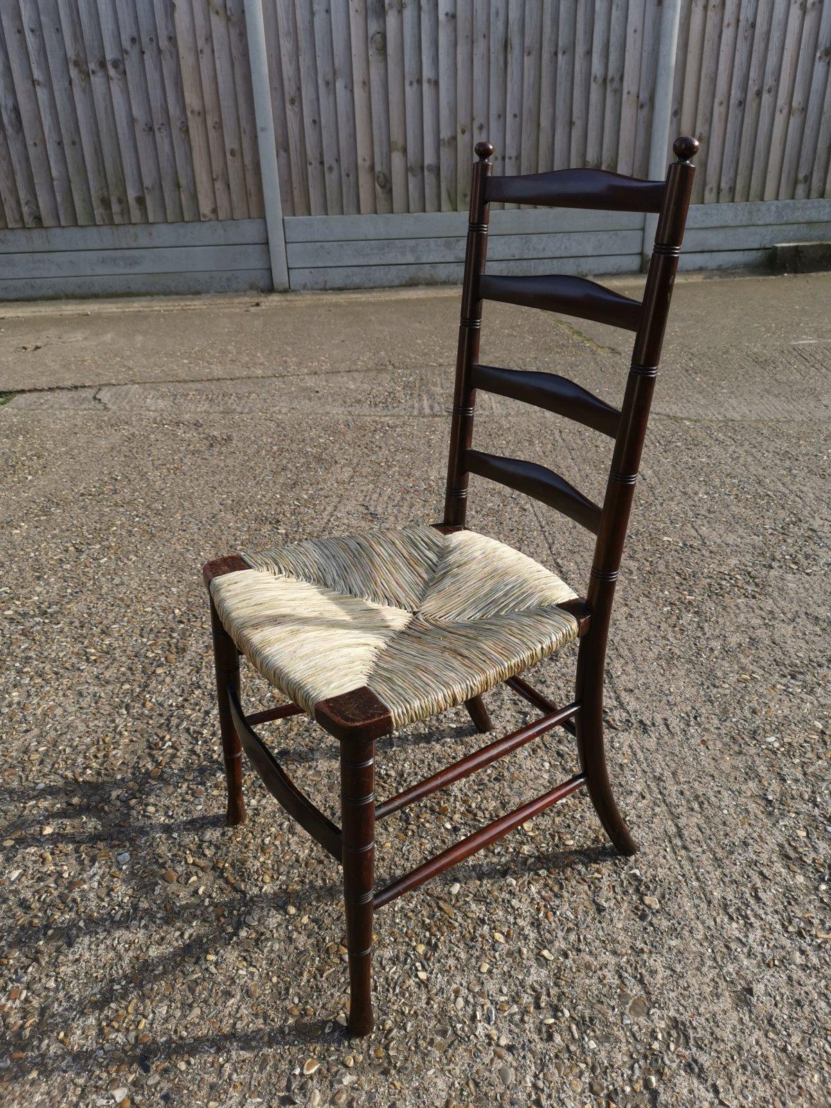 Liberty & Co. An English Aesthetic Movement Walnut Ladder Back Rush Seat Chair In Good Condition For Sale In London, GB